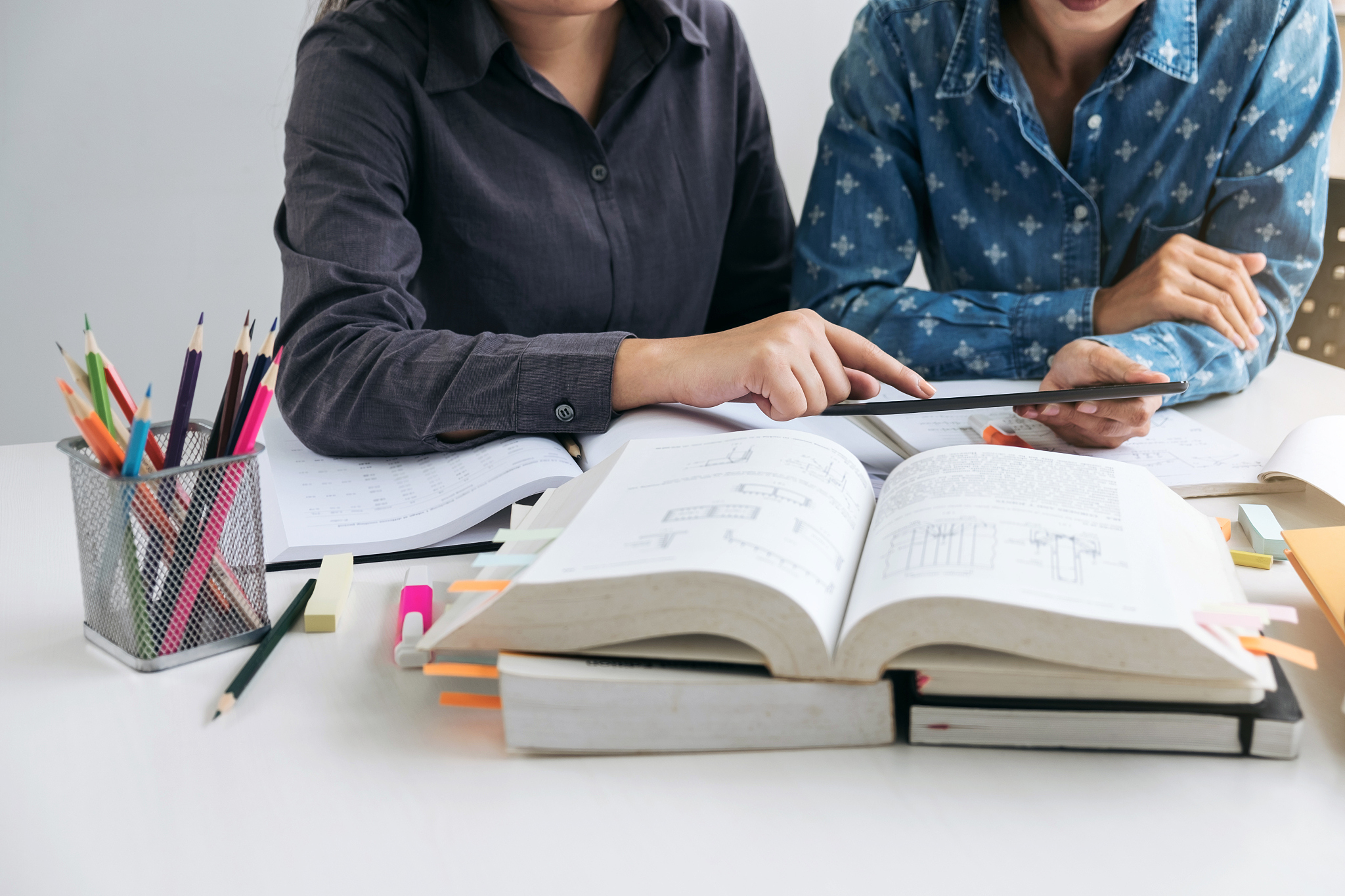 tutor books with friends, young students campus or classmates he
