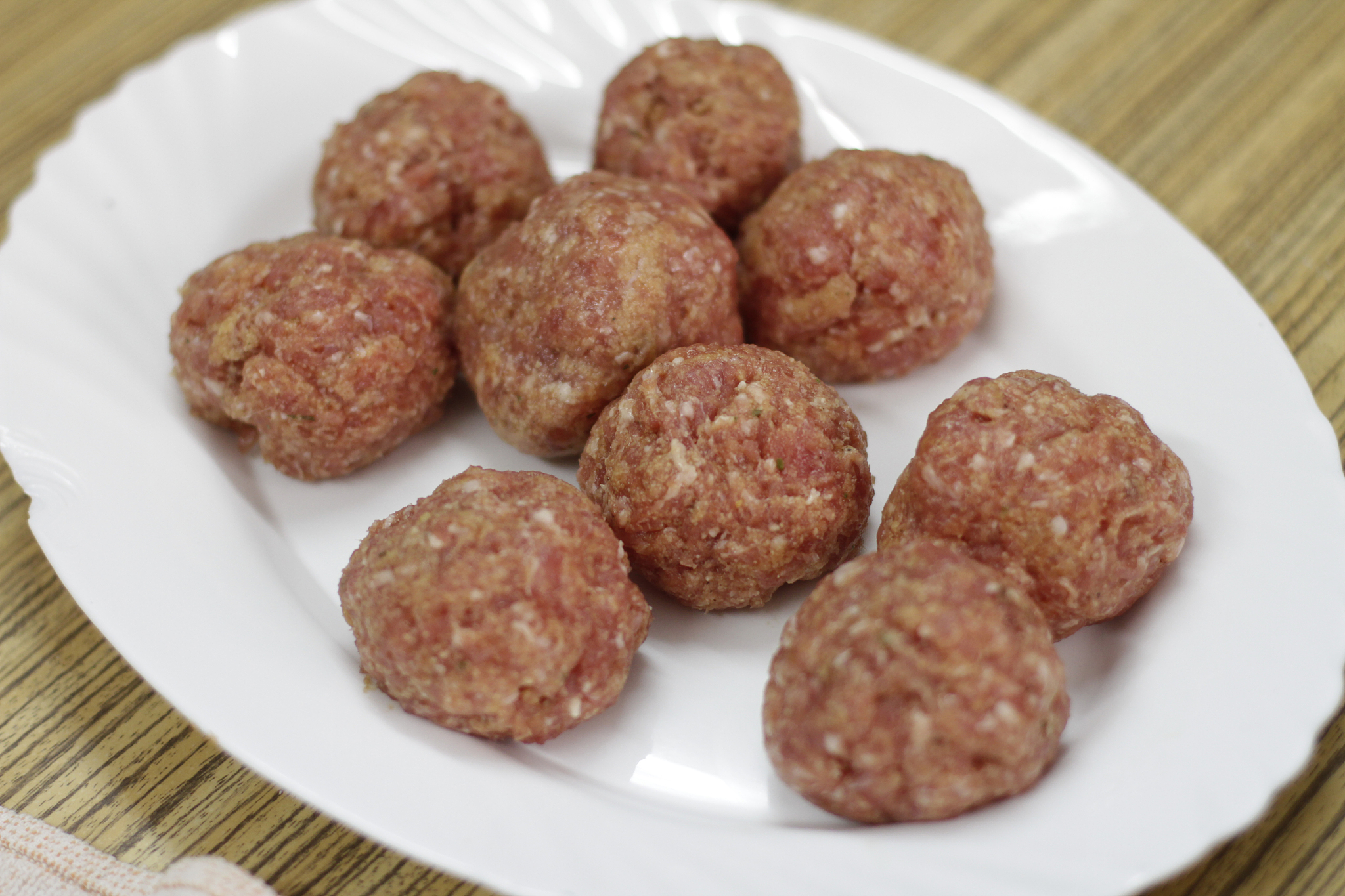 raw meatballs on white plate