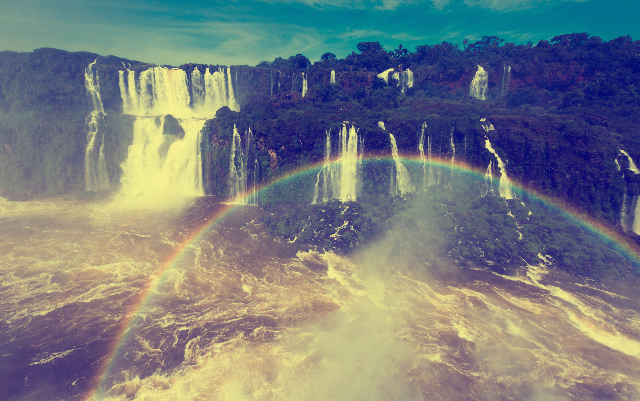 rainbow over cataratas del iguazu waterfall, brazil