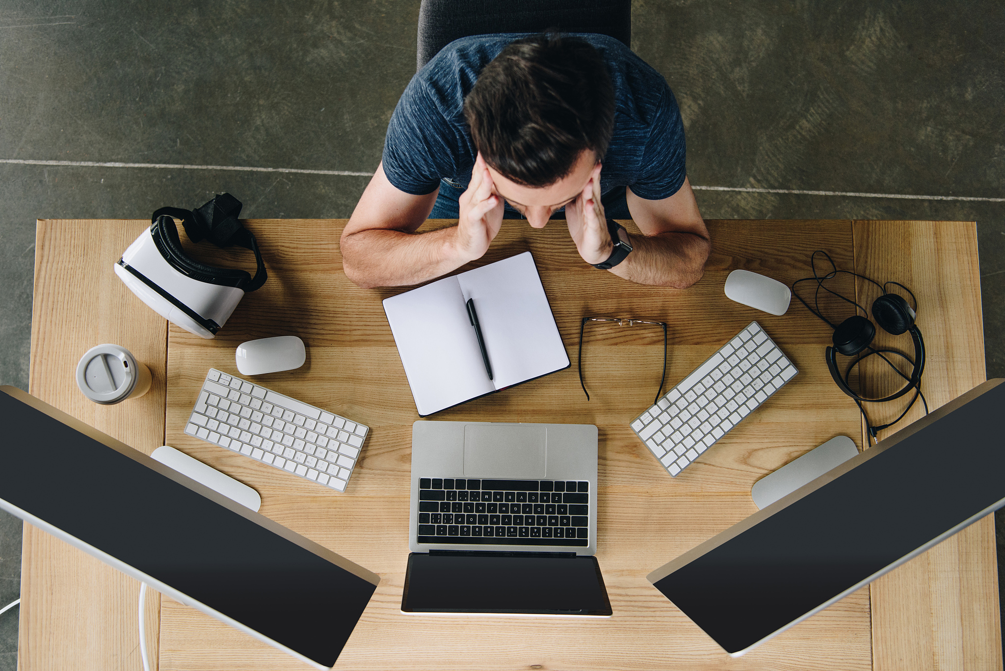 overhead view view of focused young man working with laptop and 