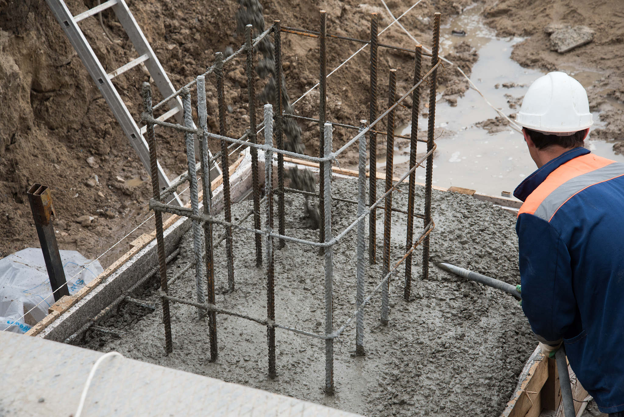 the process of compacting and smoothing fresh concrete. concrete