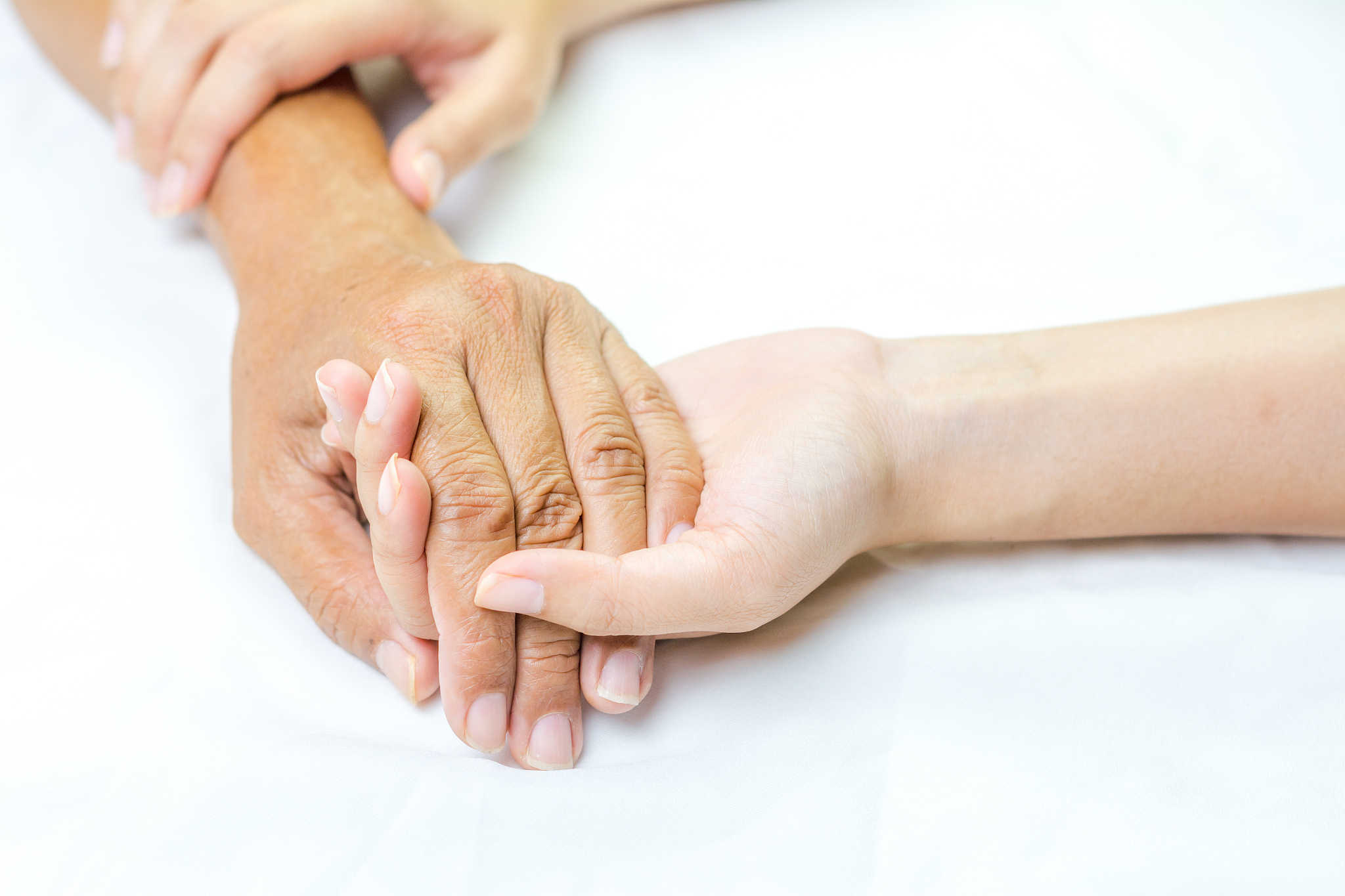 asian senior and asian young holding hands.