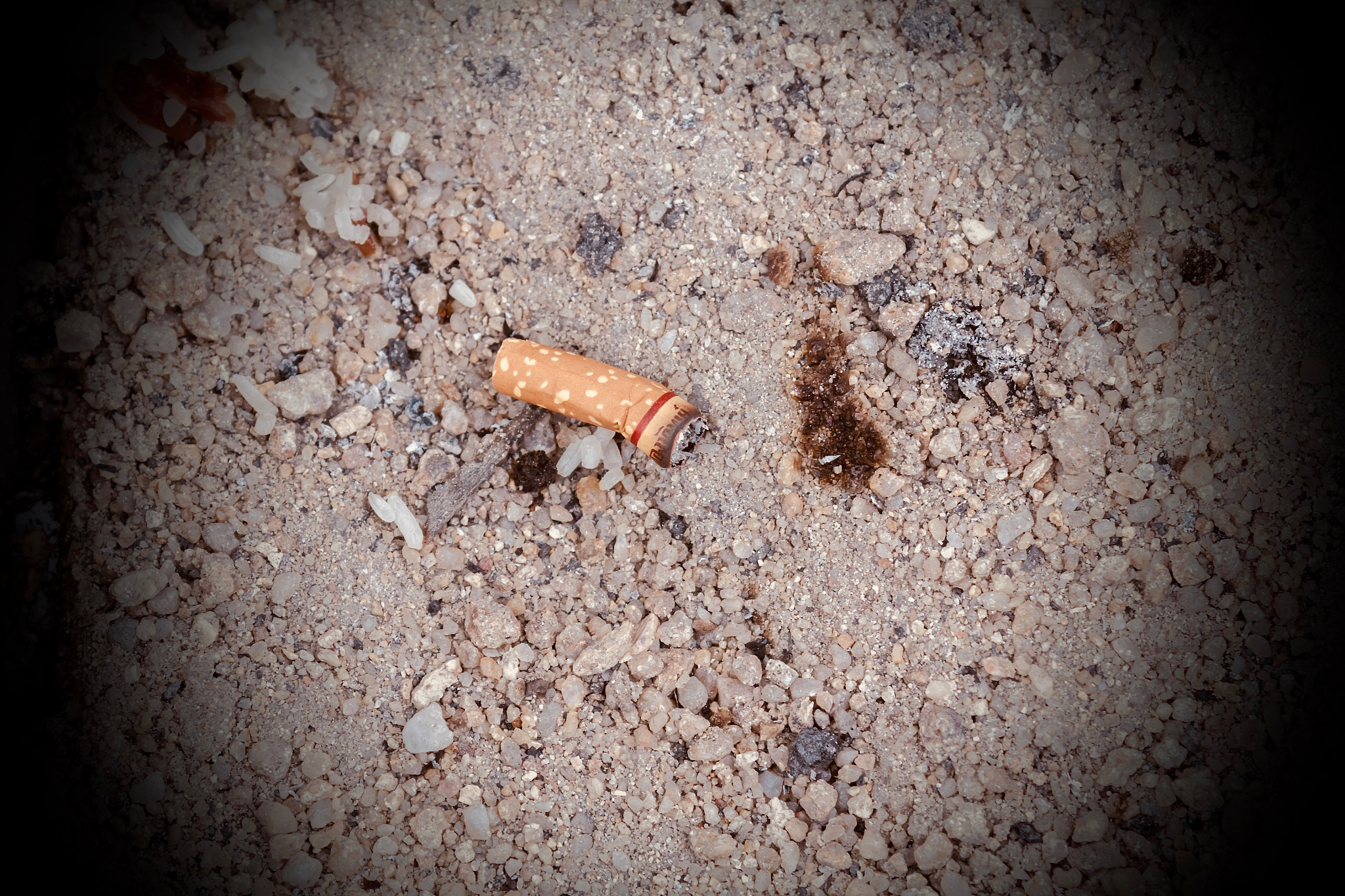 cigarette butts in the sand.