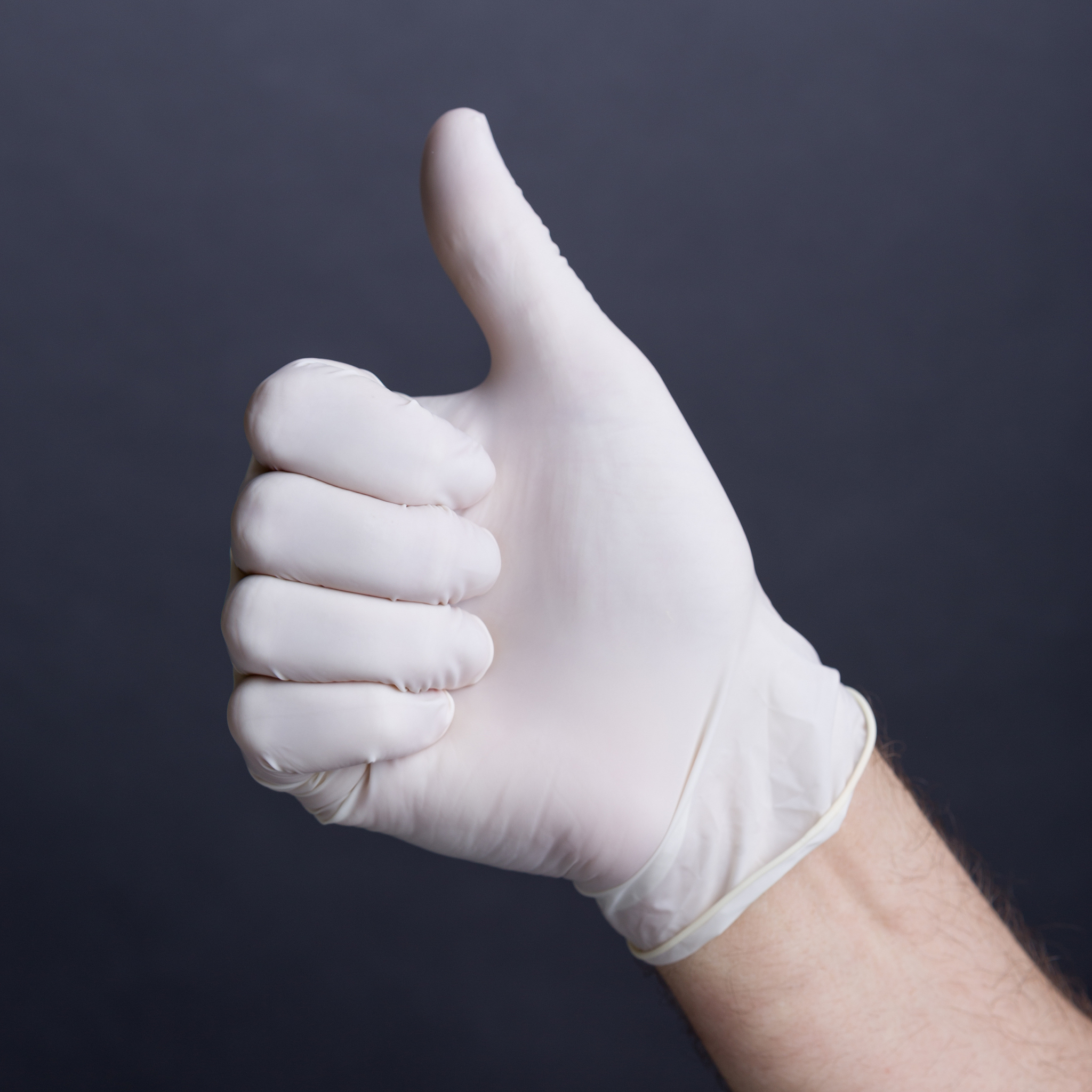 male hand in latex glove - thumb up
