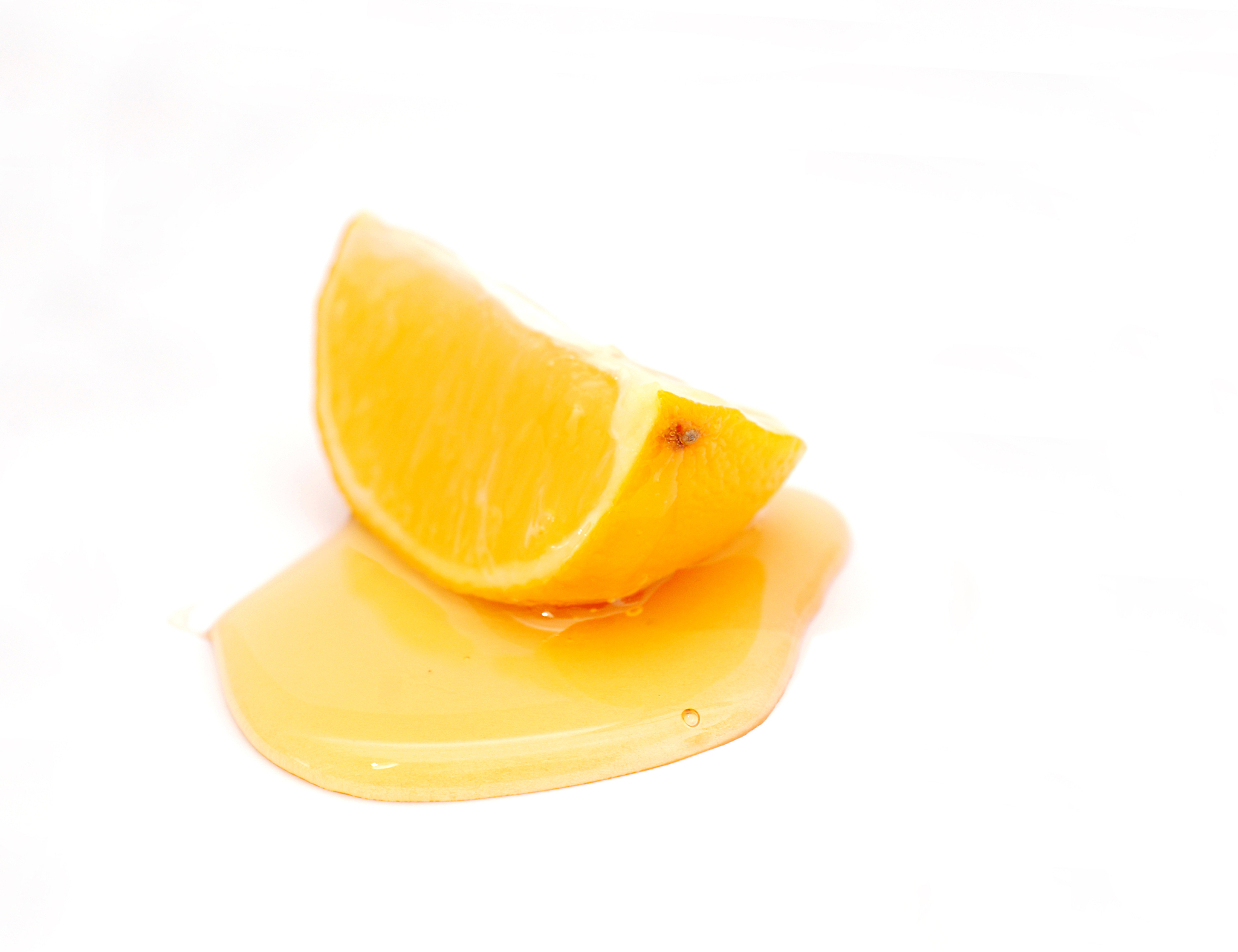 slice of lemon and honey , shallow dof, white background