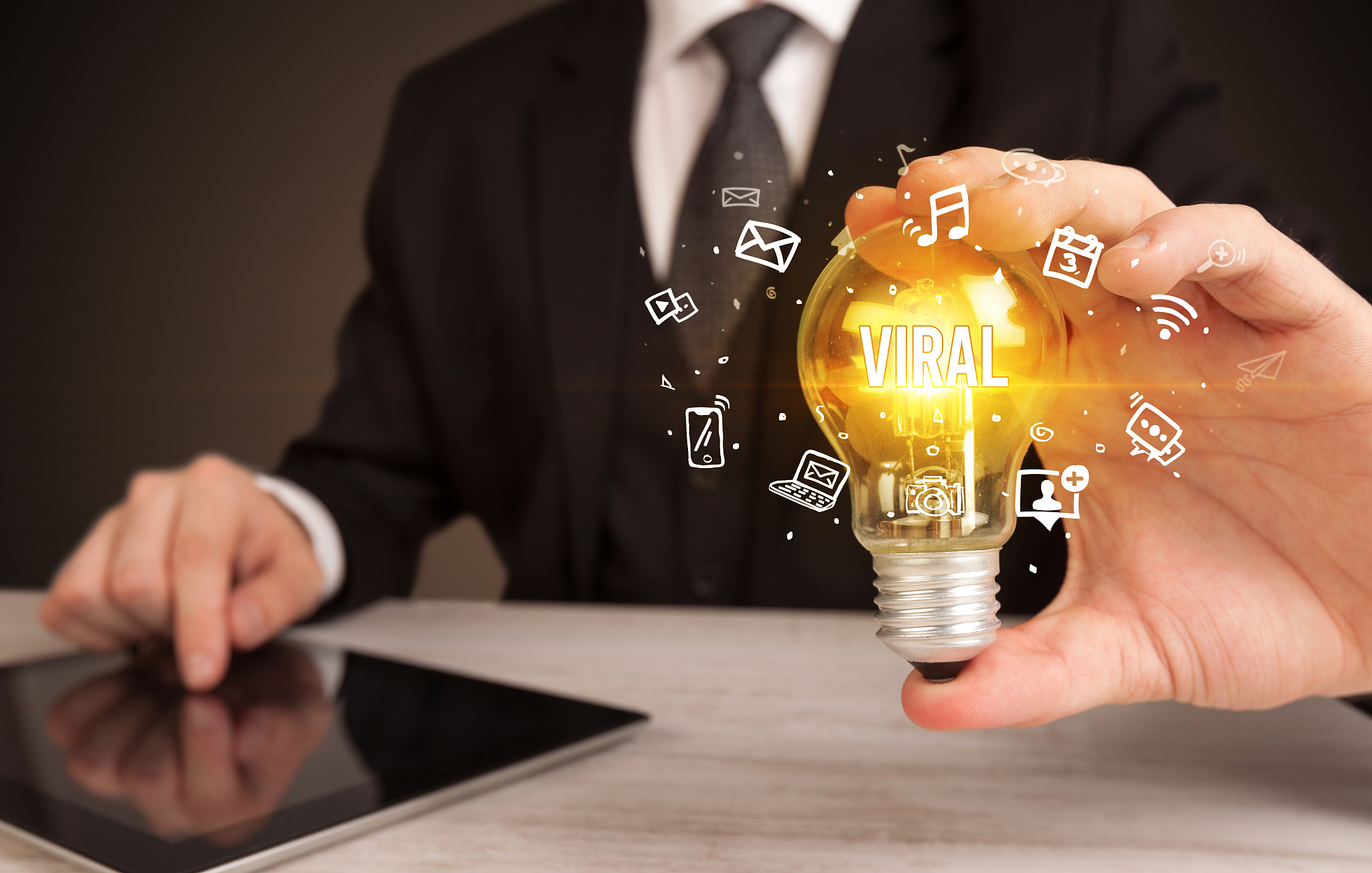 businessman holding a light bulb, social media concept