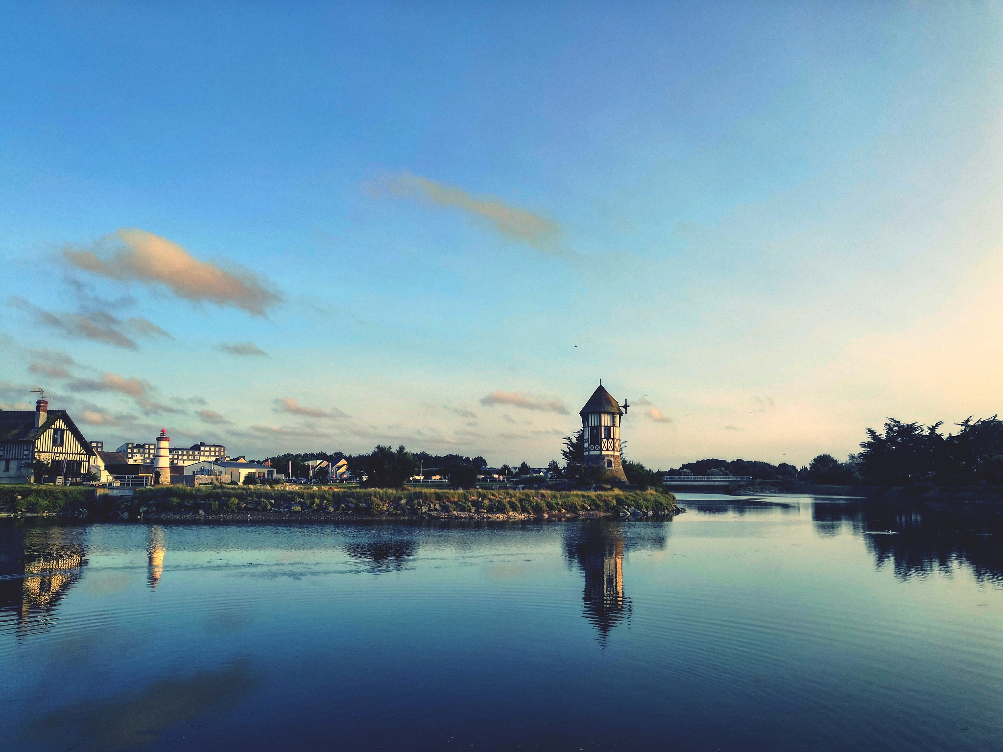 scenic view of river against sky at sunset