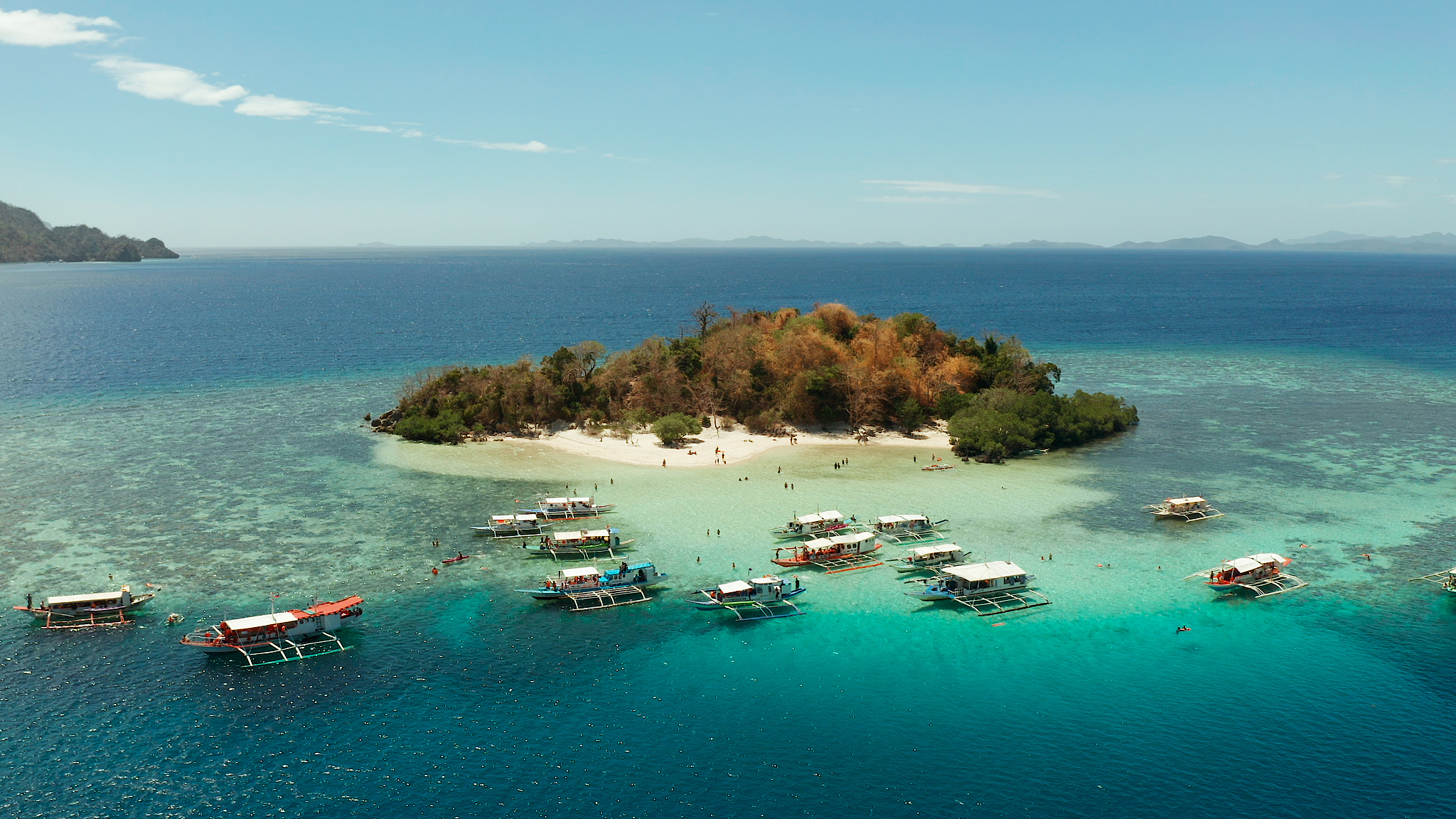 small torpical island with white sandy beach, top view