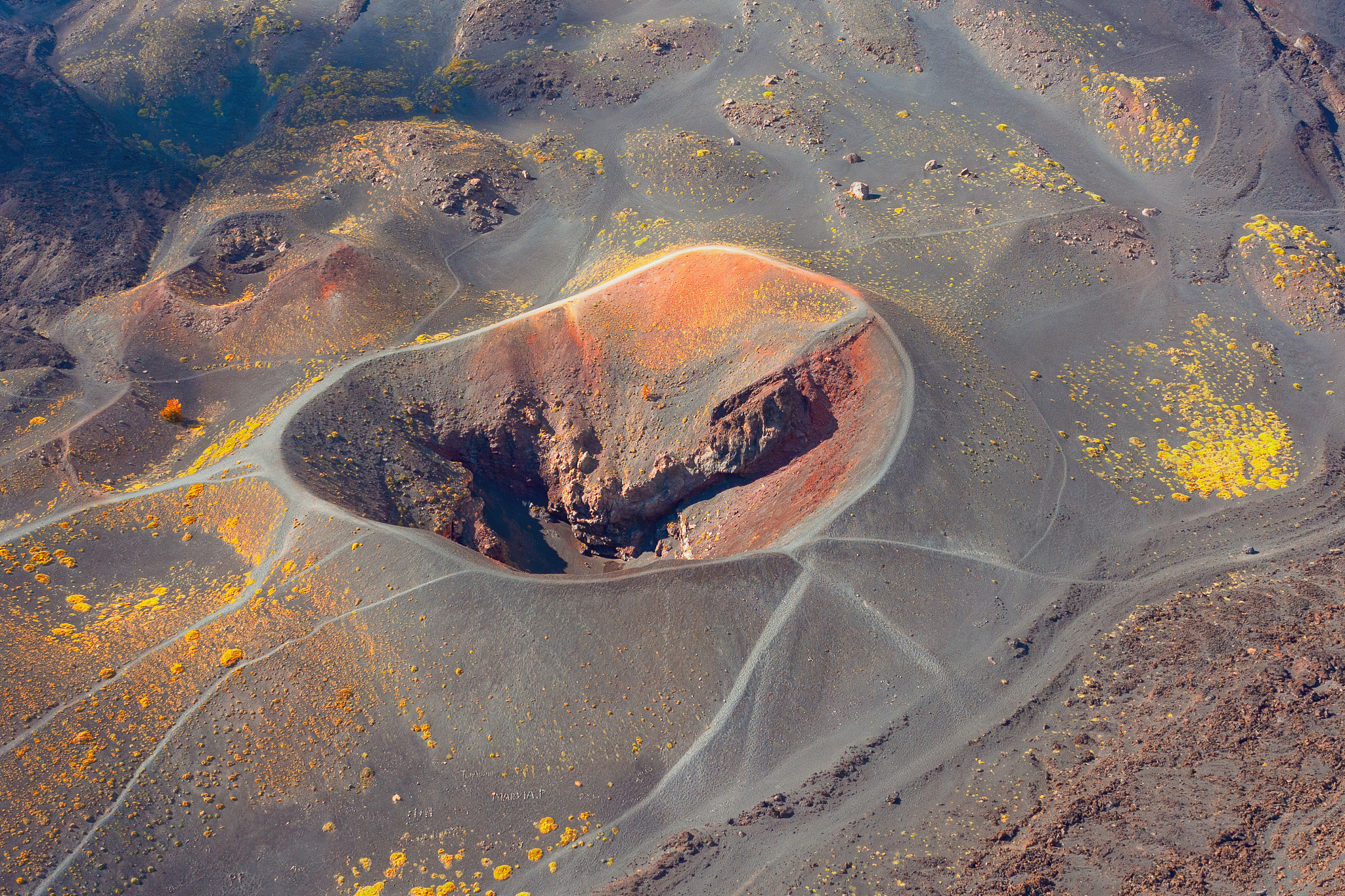 volcanic crater on the side of the mountain, around hardened lav