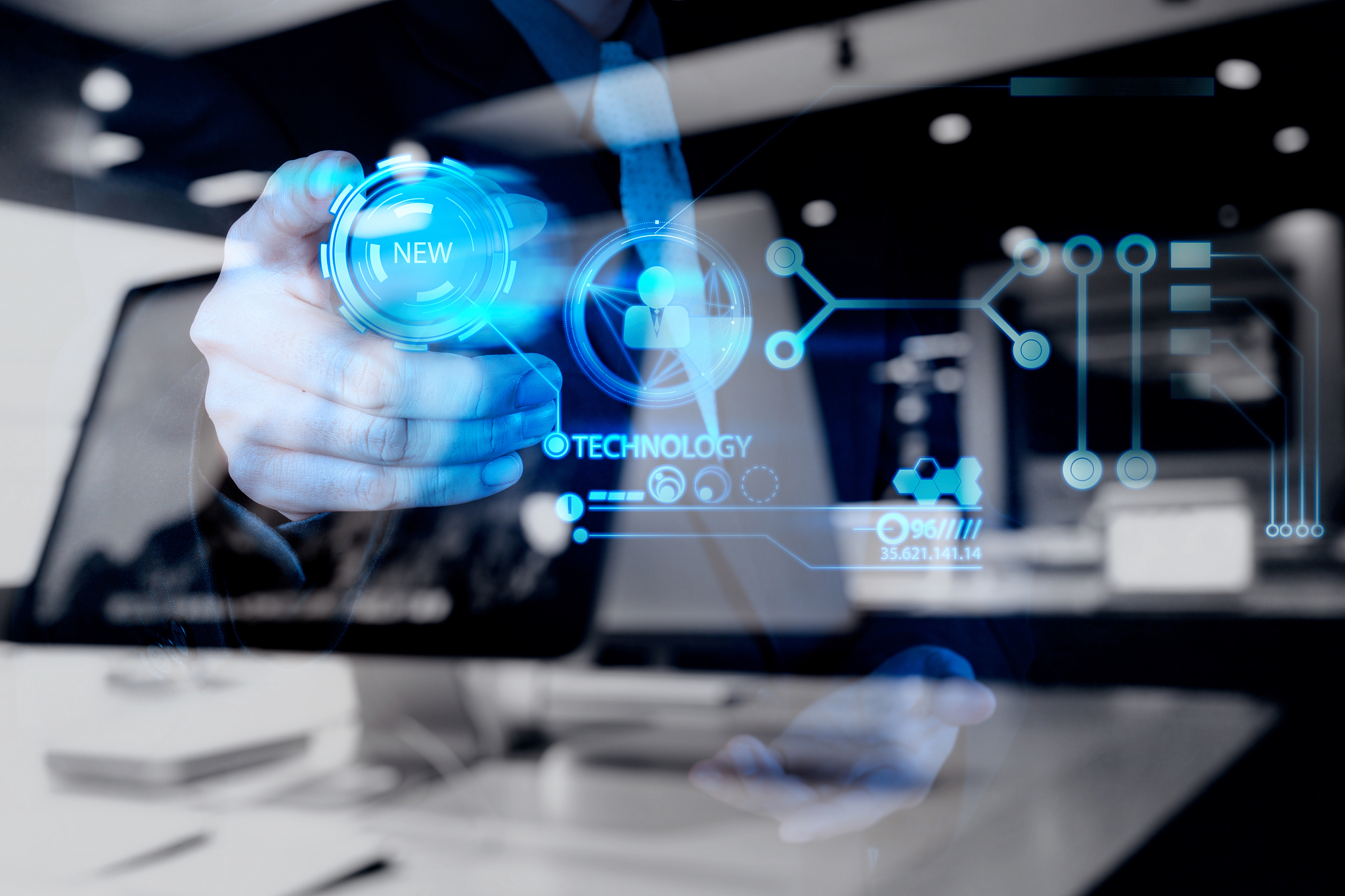 businessman hand pushing new technology button on modern comput