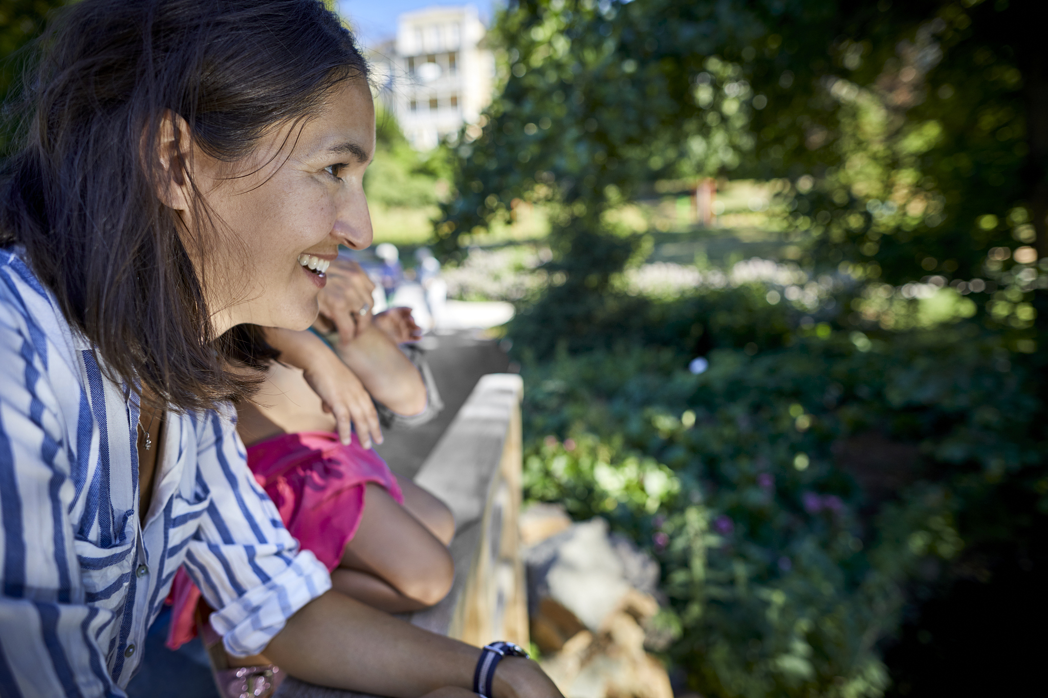 smiling woman with her family in a park