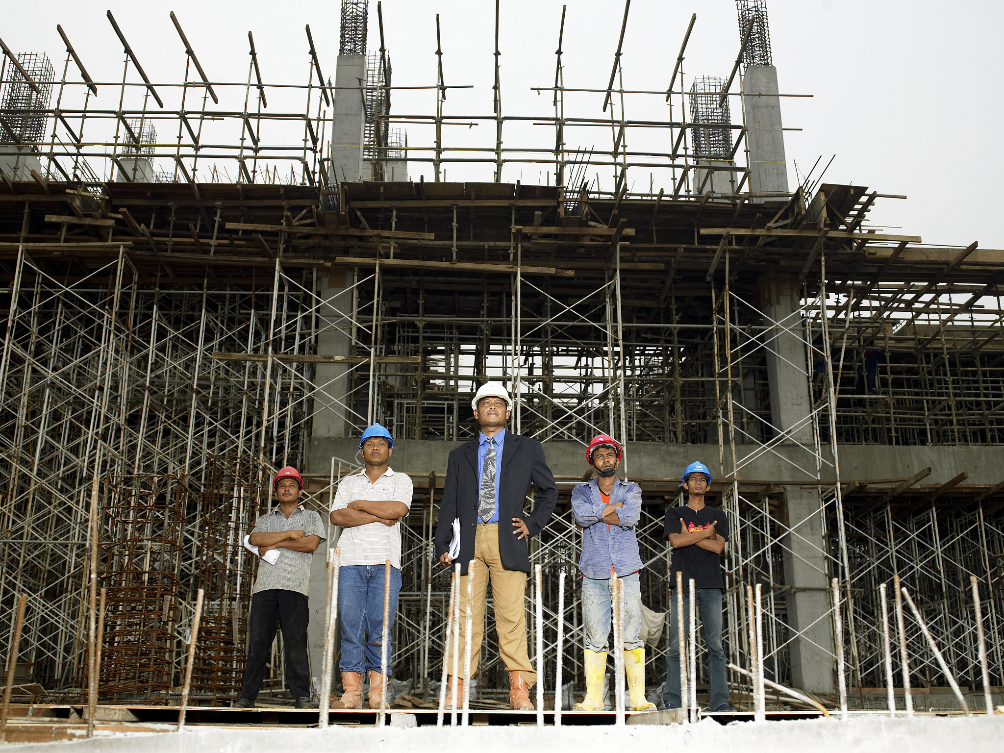 construction supervisor and workmen at building site