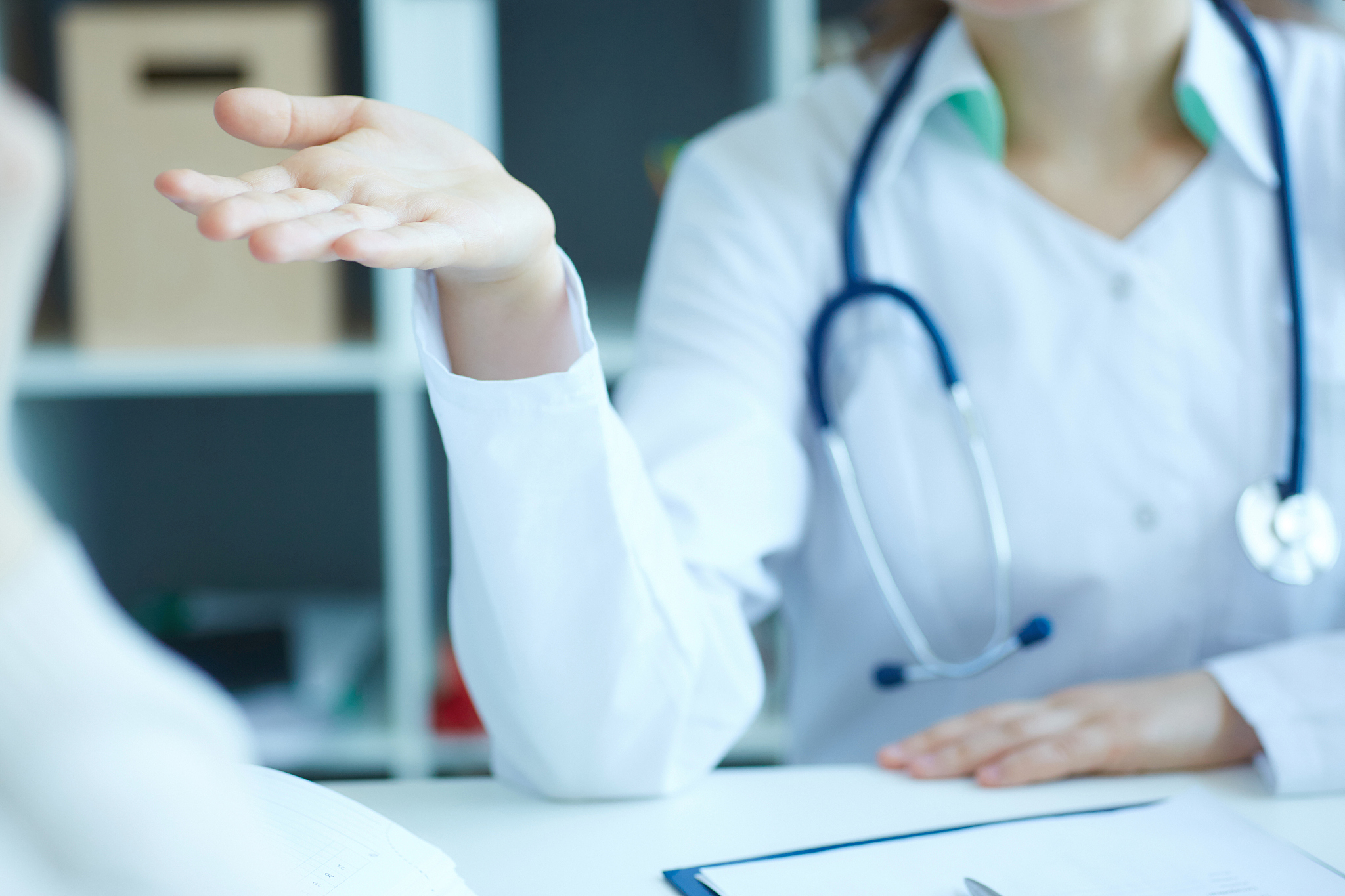 doctor and patient are discussing something, just hands at the t