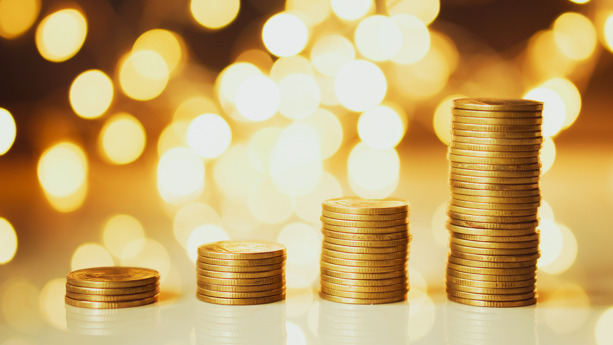 close-up of stack of coins on table against defocused lights