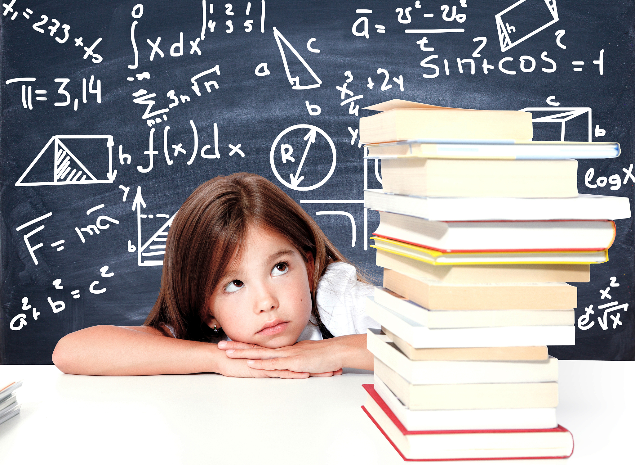 young cute girl sitting at the table and reading a book