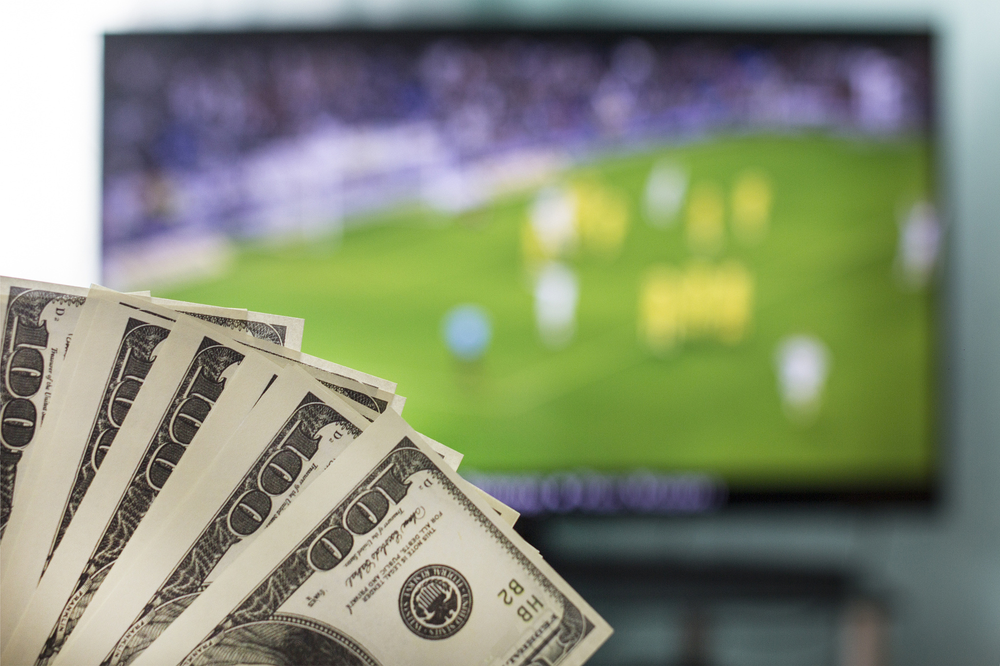 dollars against the backdrop of a tv set for football, football 