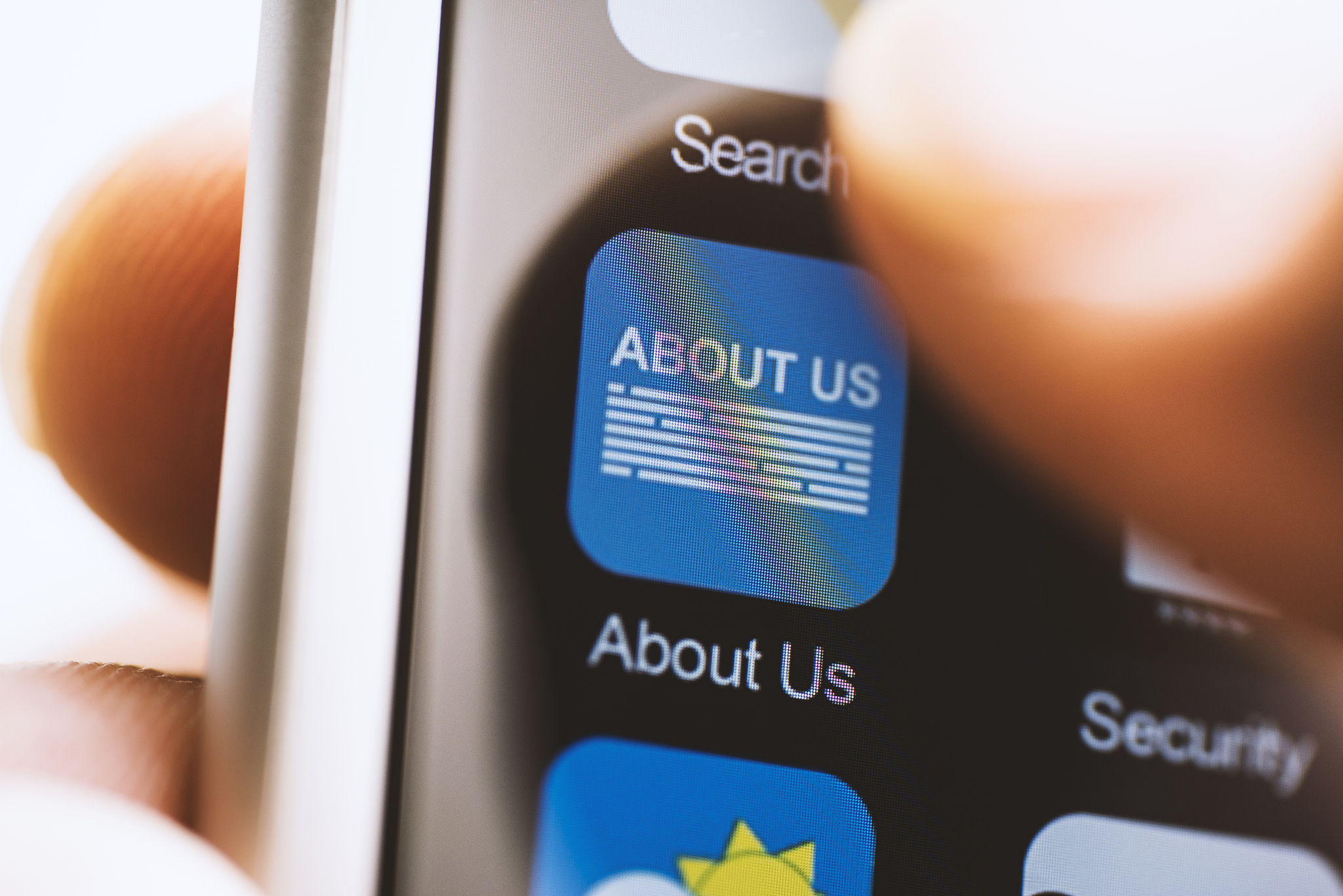 hand touching about us app on screen