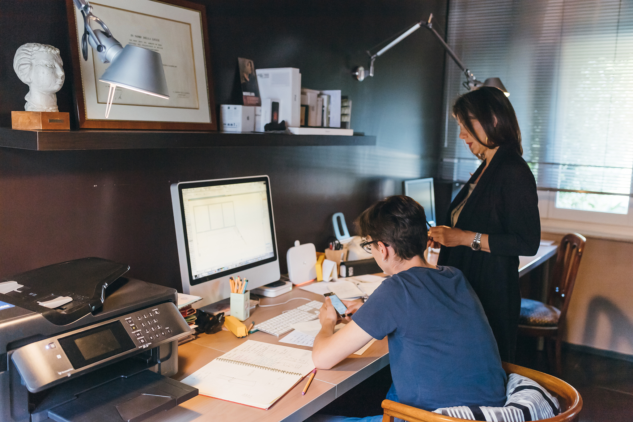 woman and son working in home office