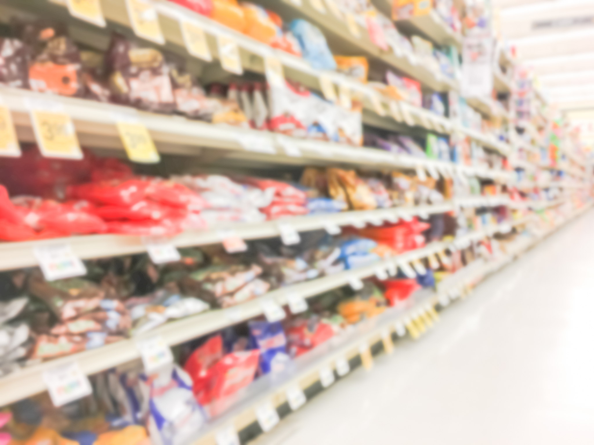 abstract blurred candy, chips, cookies at grocery store in usa