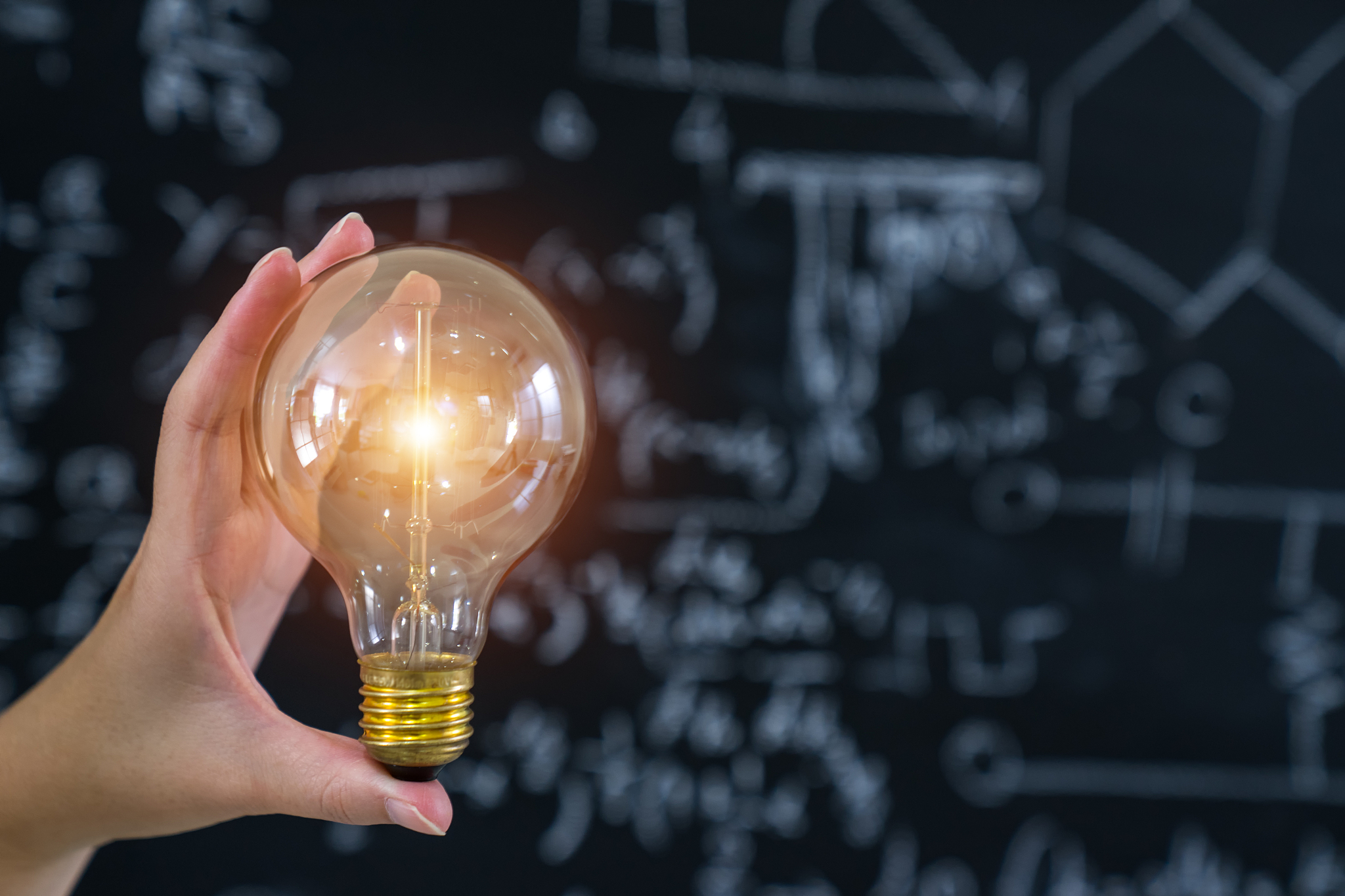 hand holding light bulb concept and education.