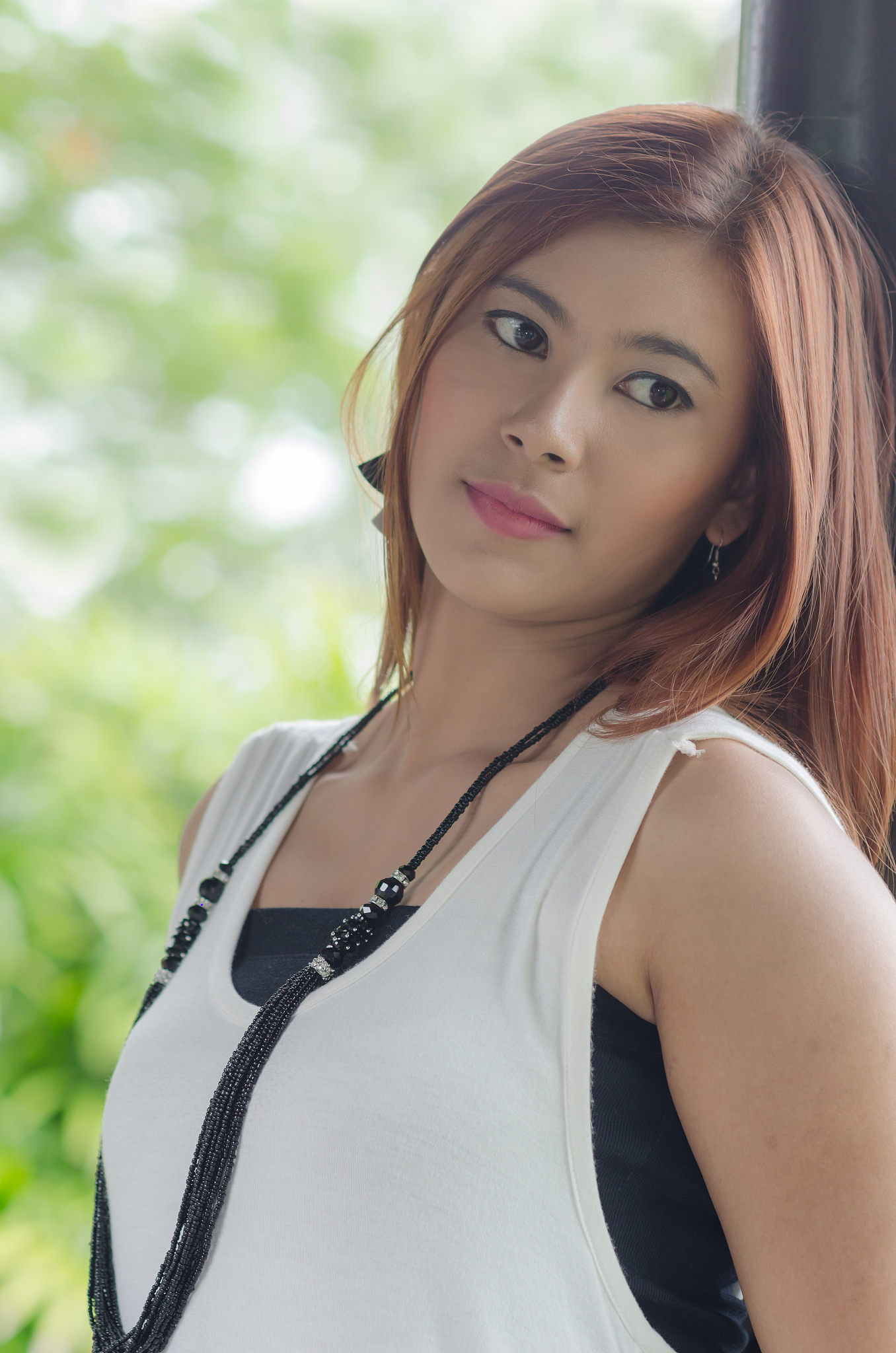 beautiful happy redhead young woman in a park