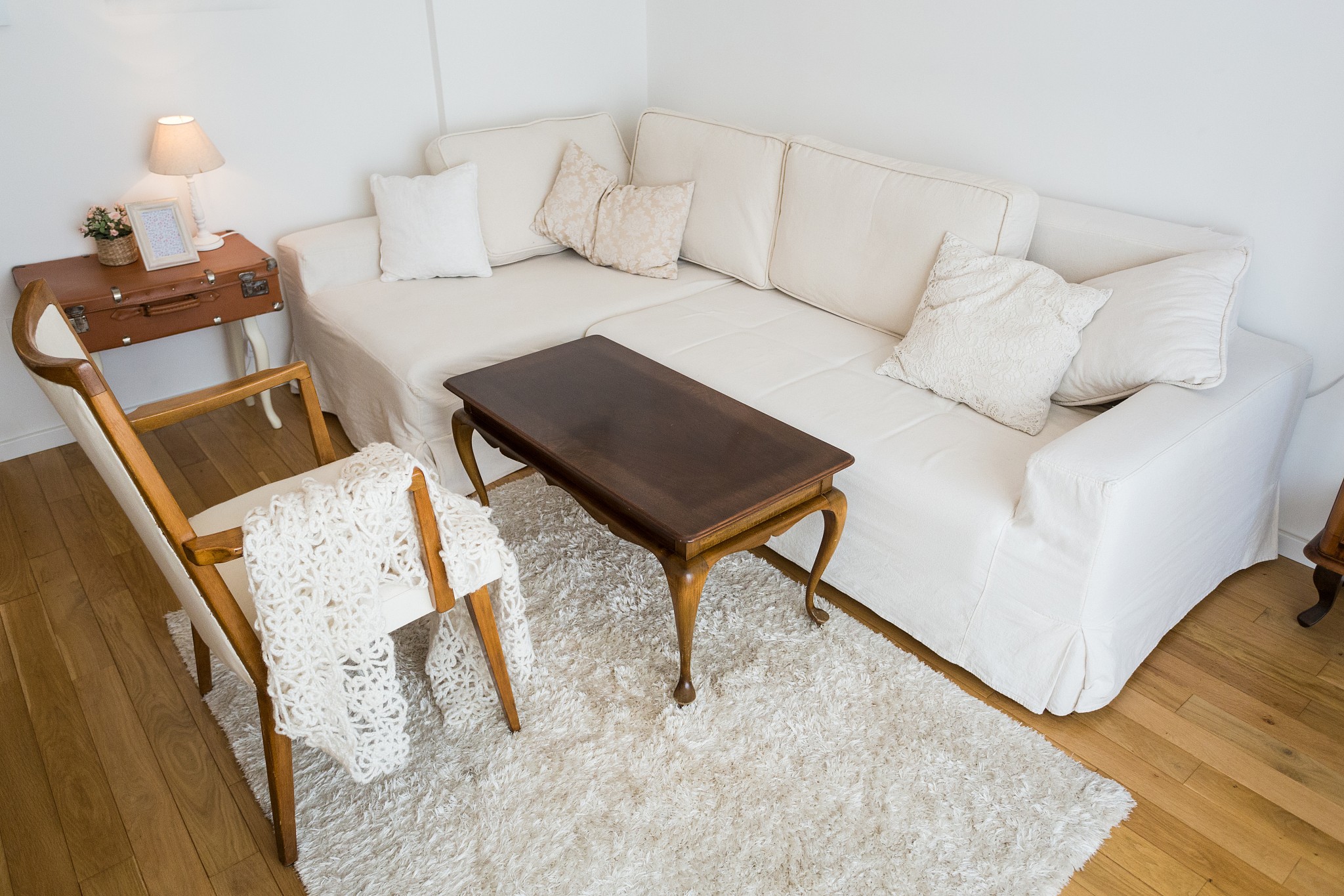 bright living room with white sofa and vintage decor.