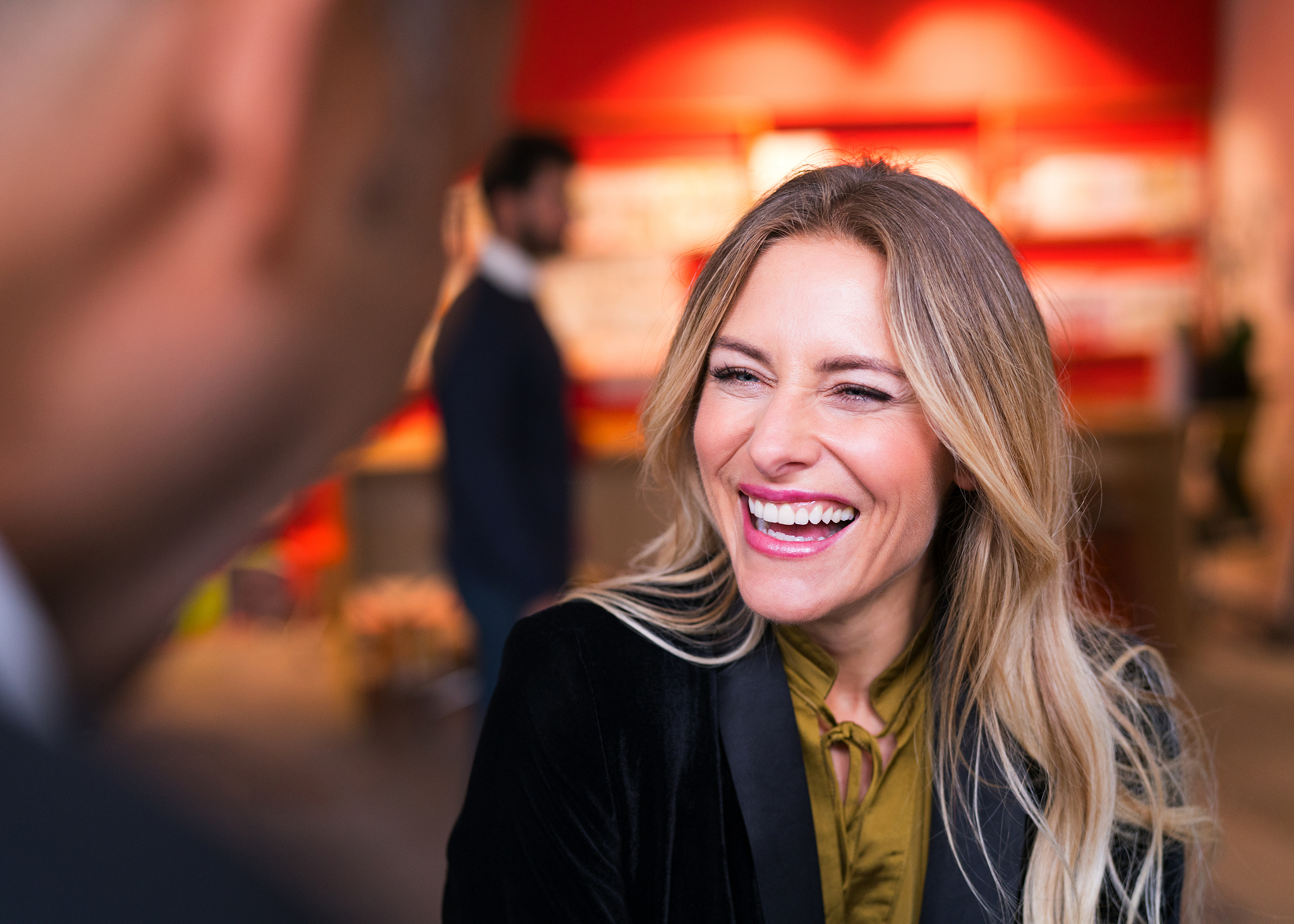 cheerful businesswoman with colleague in office