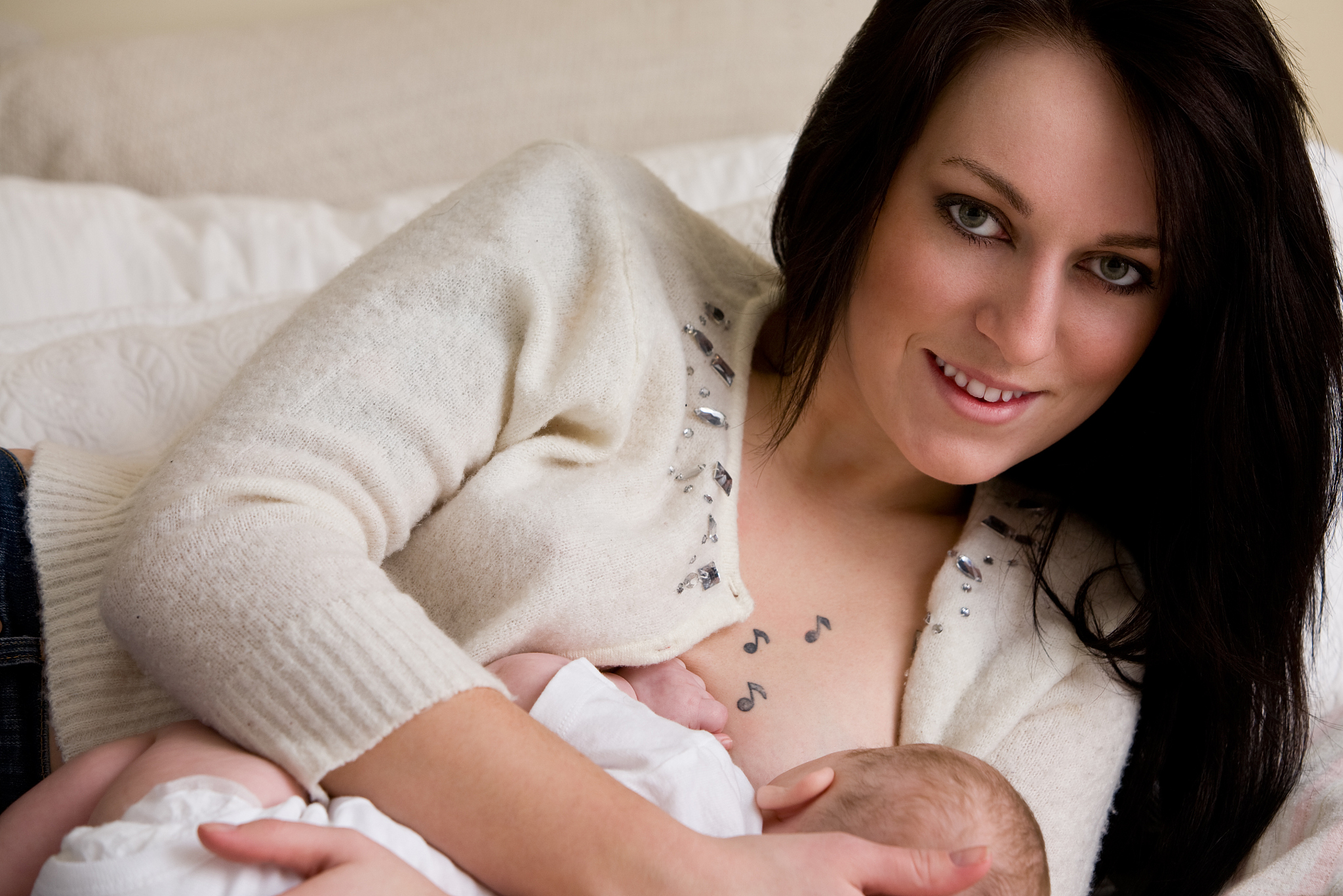 young mother nurses infant daughter