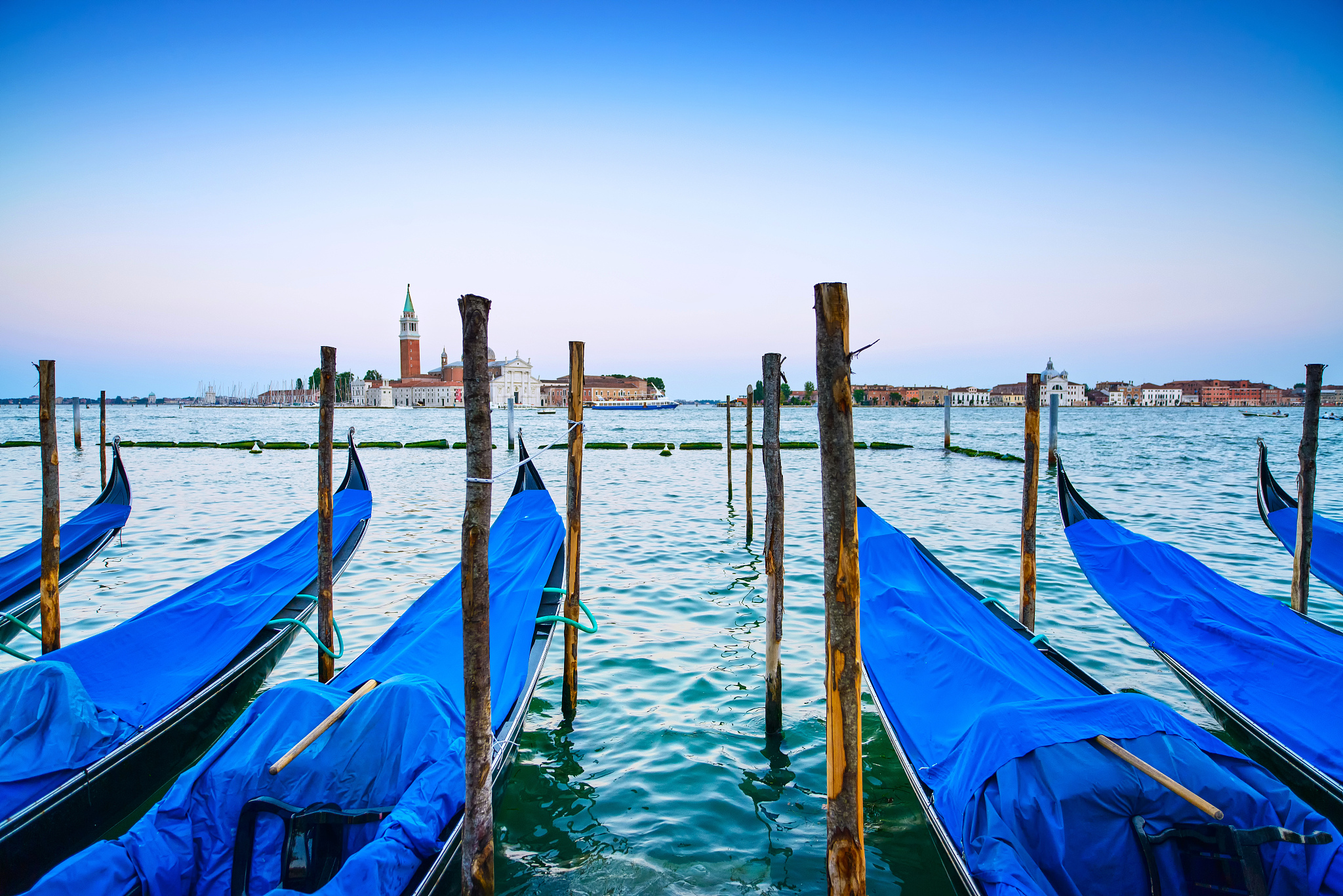venice, gondolas or gondole on sunset and church on background.