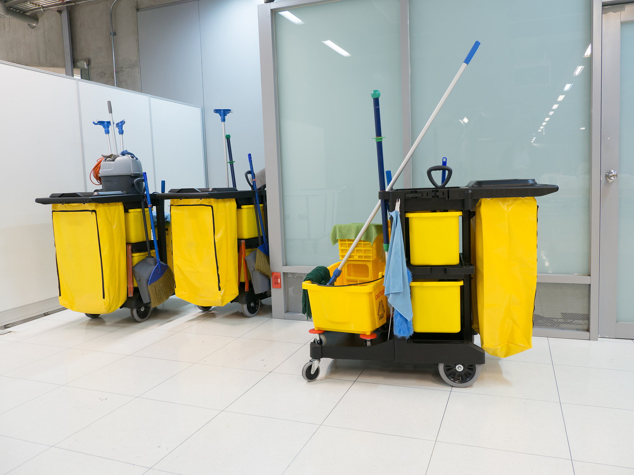 cleaning cart in the station. cleaning tools cart and yellow mop