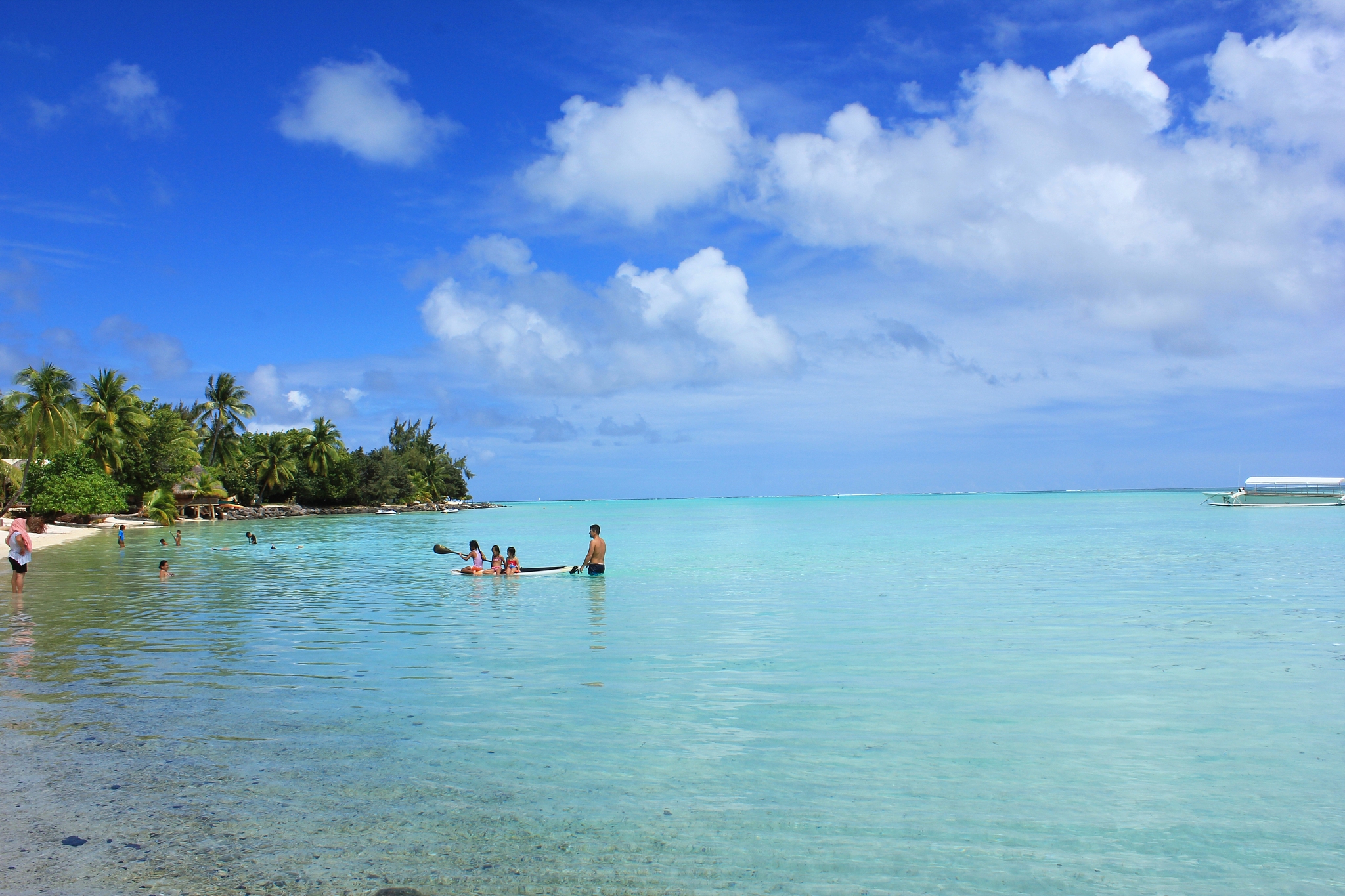 people enjoying in beach against cloudy sky