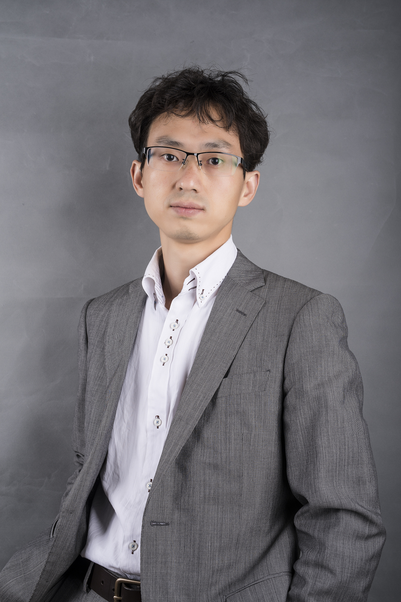 single young asian businessman in front of a gray background
