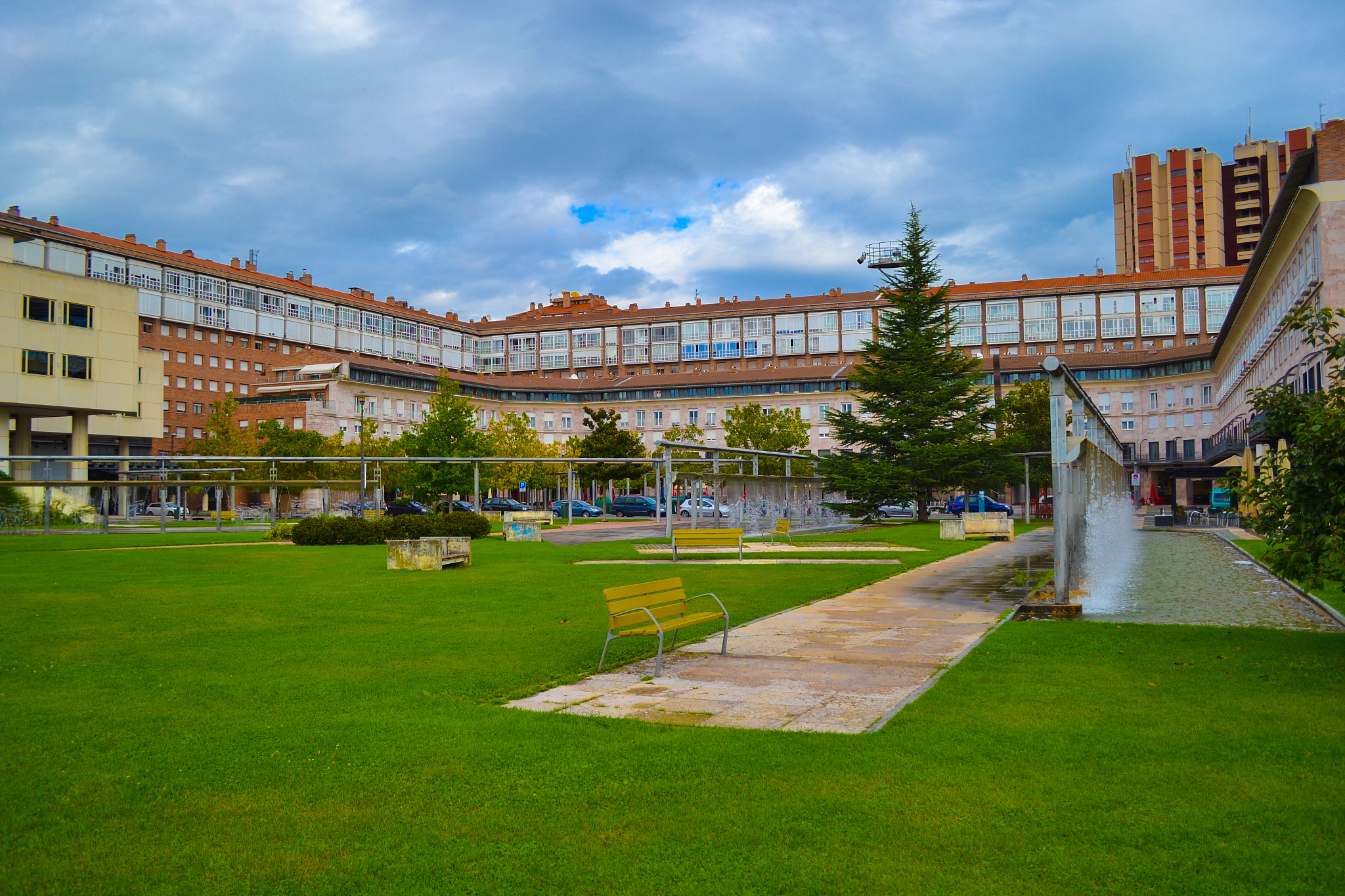 building in middle of a park with fountains and seats in pamplon