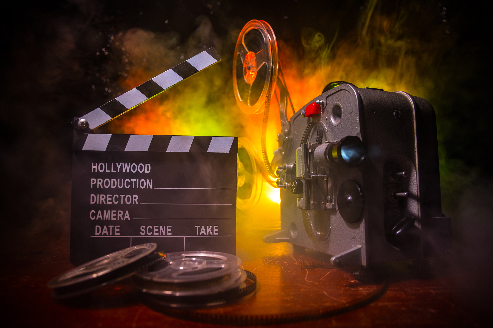 old vintage movie projector on a dark background with fog and li