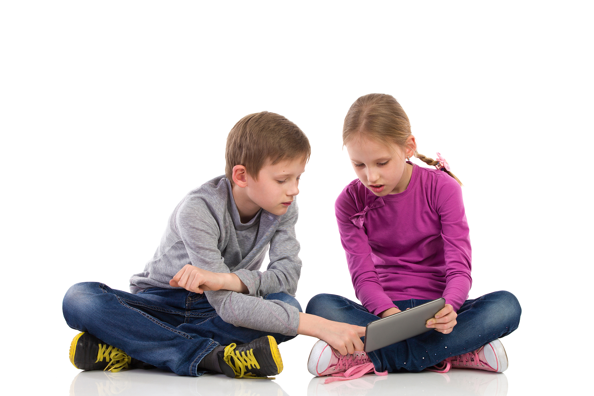 two kids using tablet