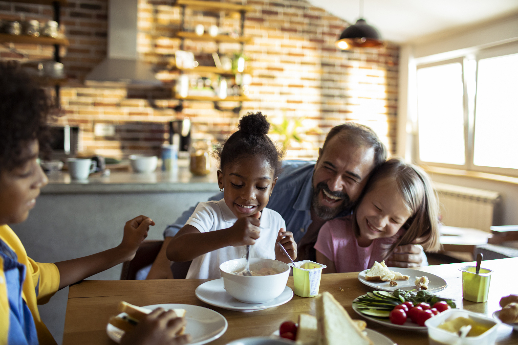 single father having breakfast with his kids