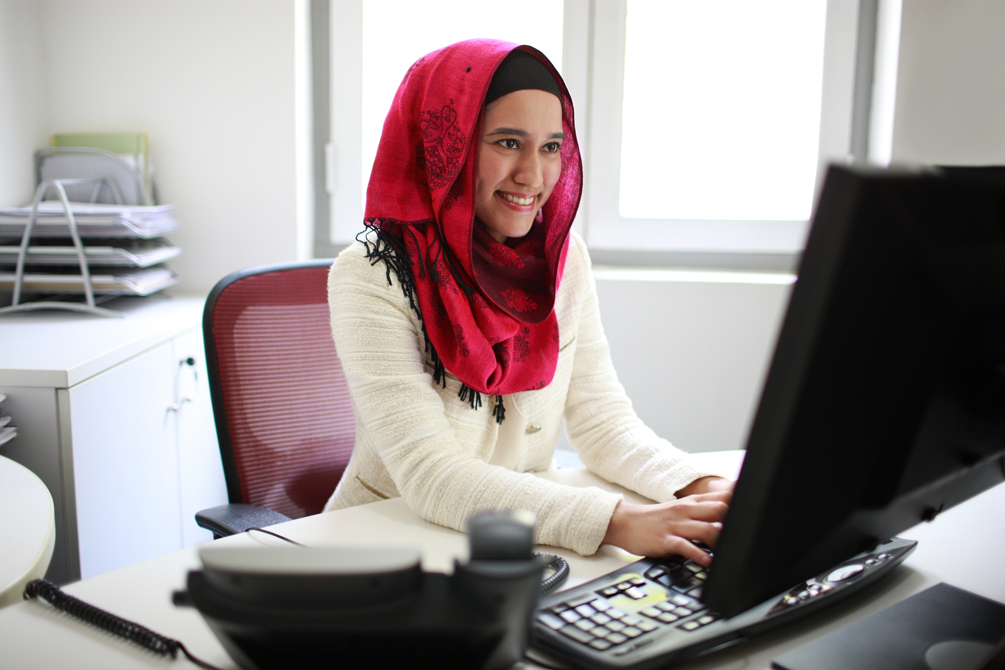 asian / malay female working on computer