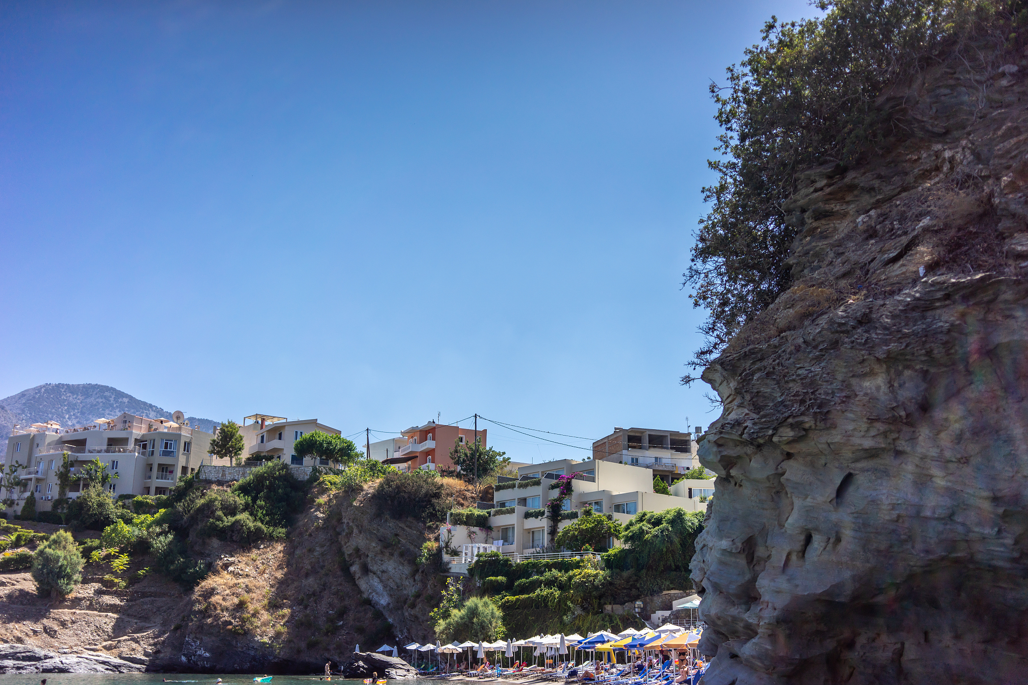 sun beds on a rock by the sea