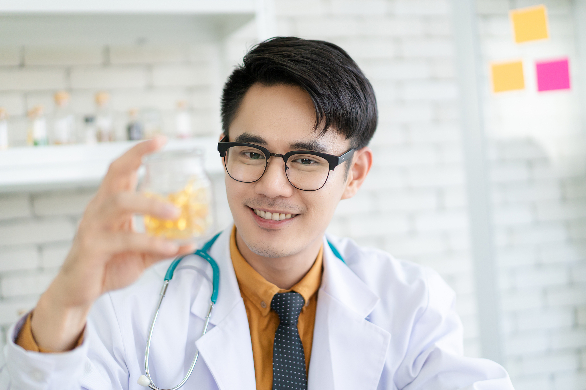asian nutritionist portrait, nutritionist showing a vitamin cals