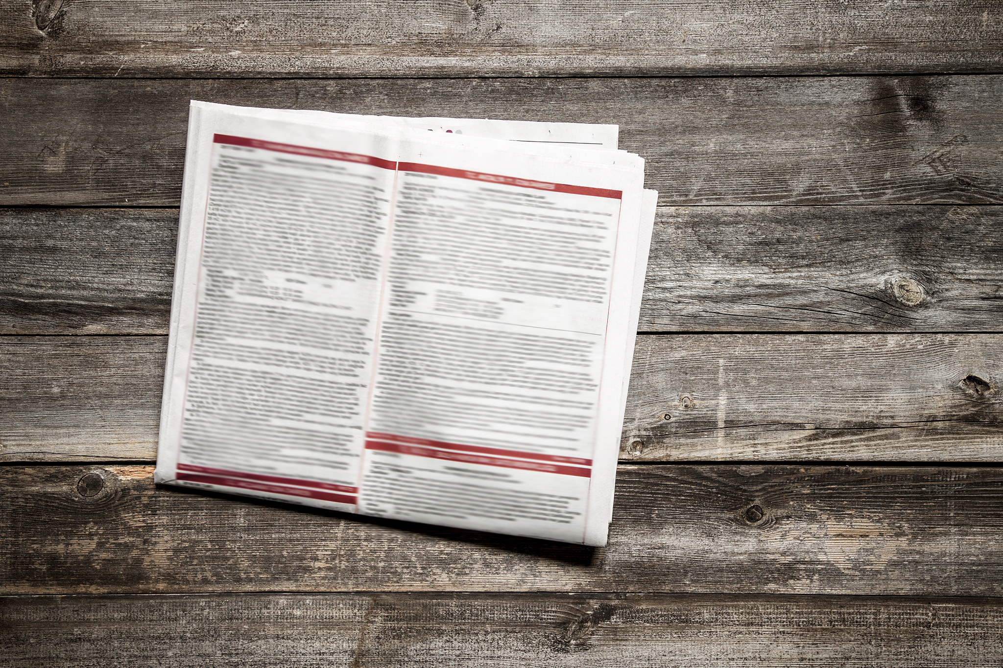 reading newspaper on wooden background