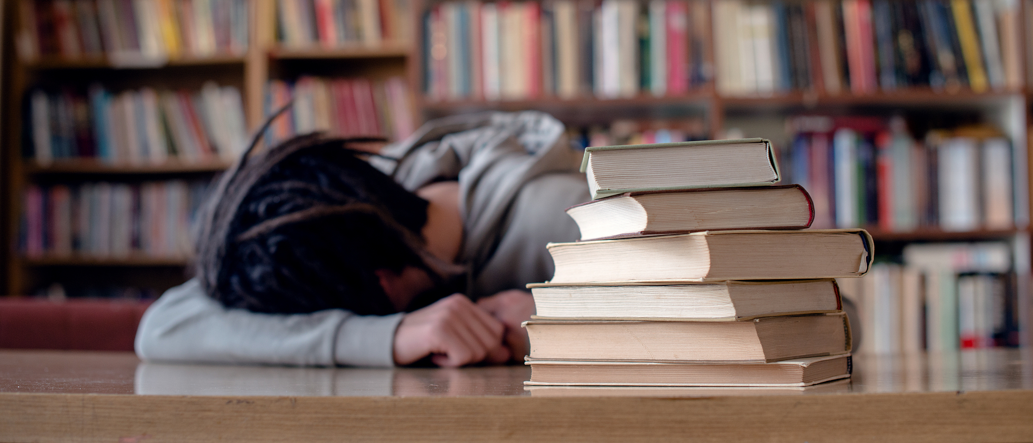 college student sleeping in library