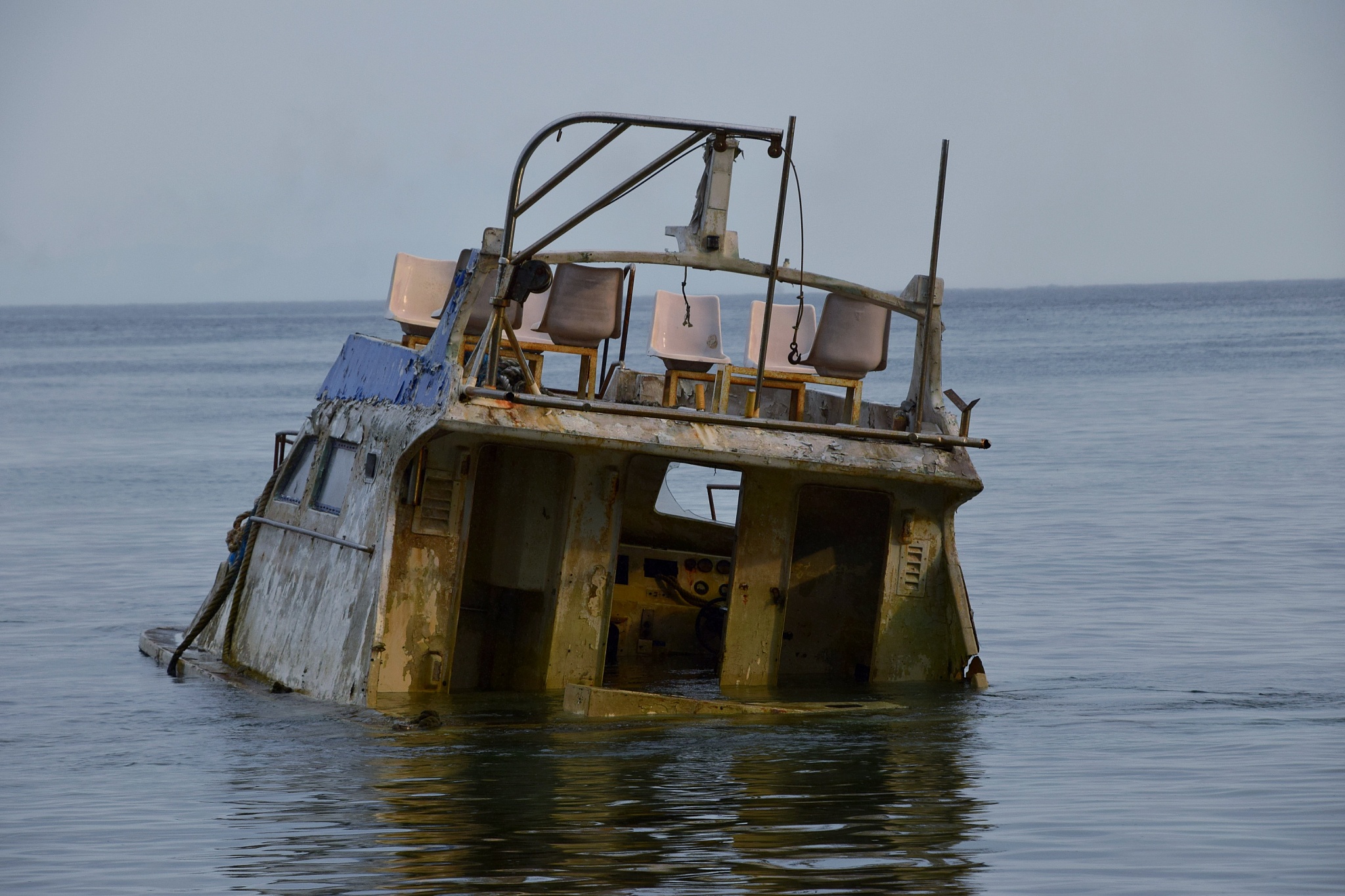 abandoned ship in sea against sky