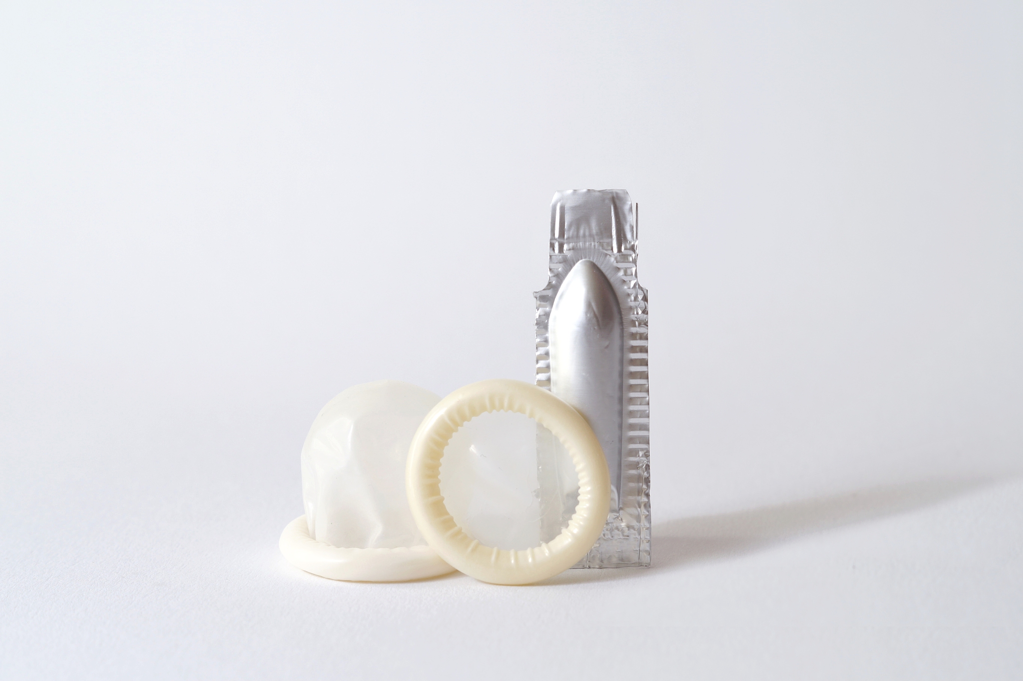 package of suppository and a latex finger cot. suppositories and