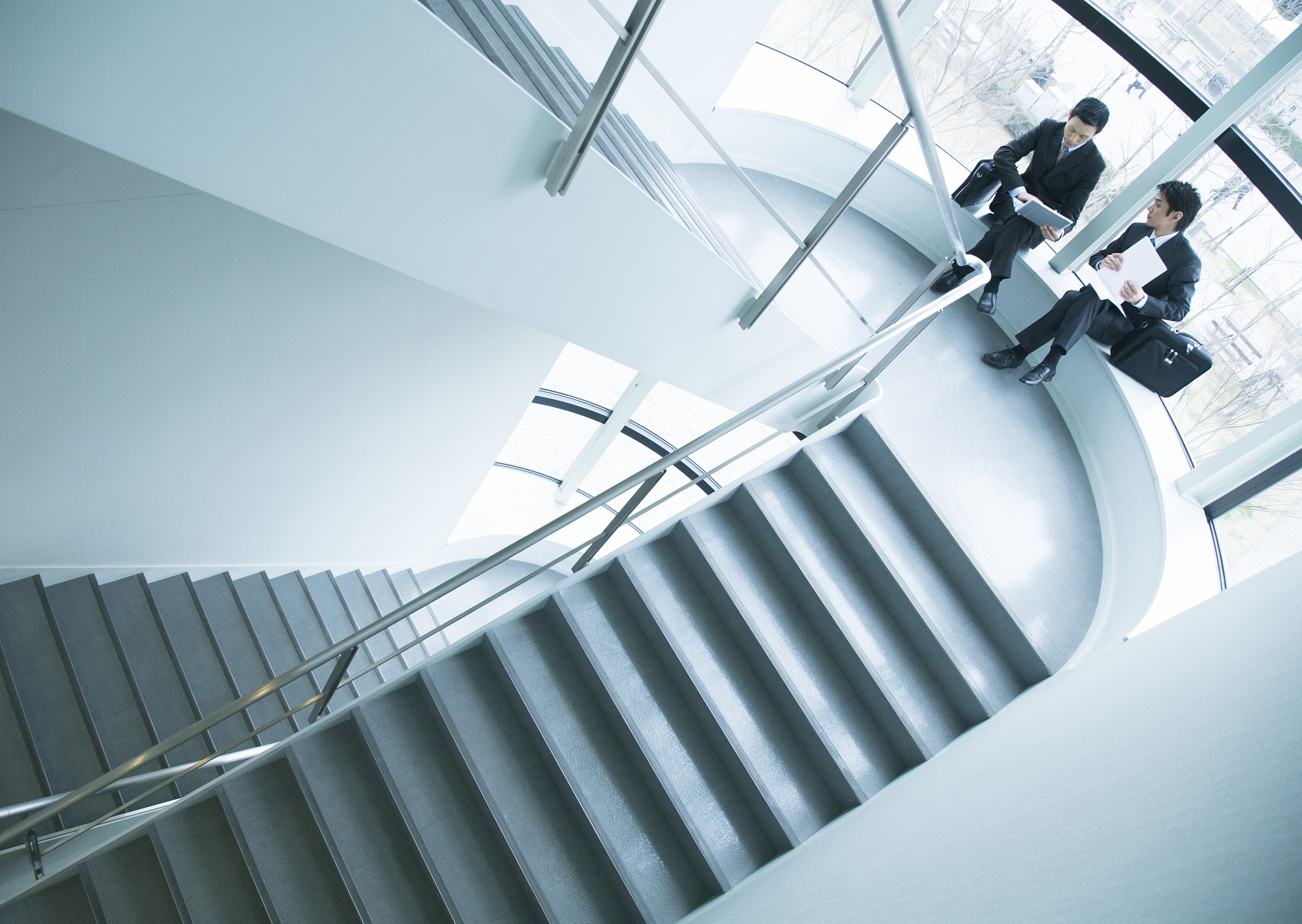 businessmen discussing on staircase landing