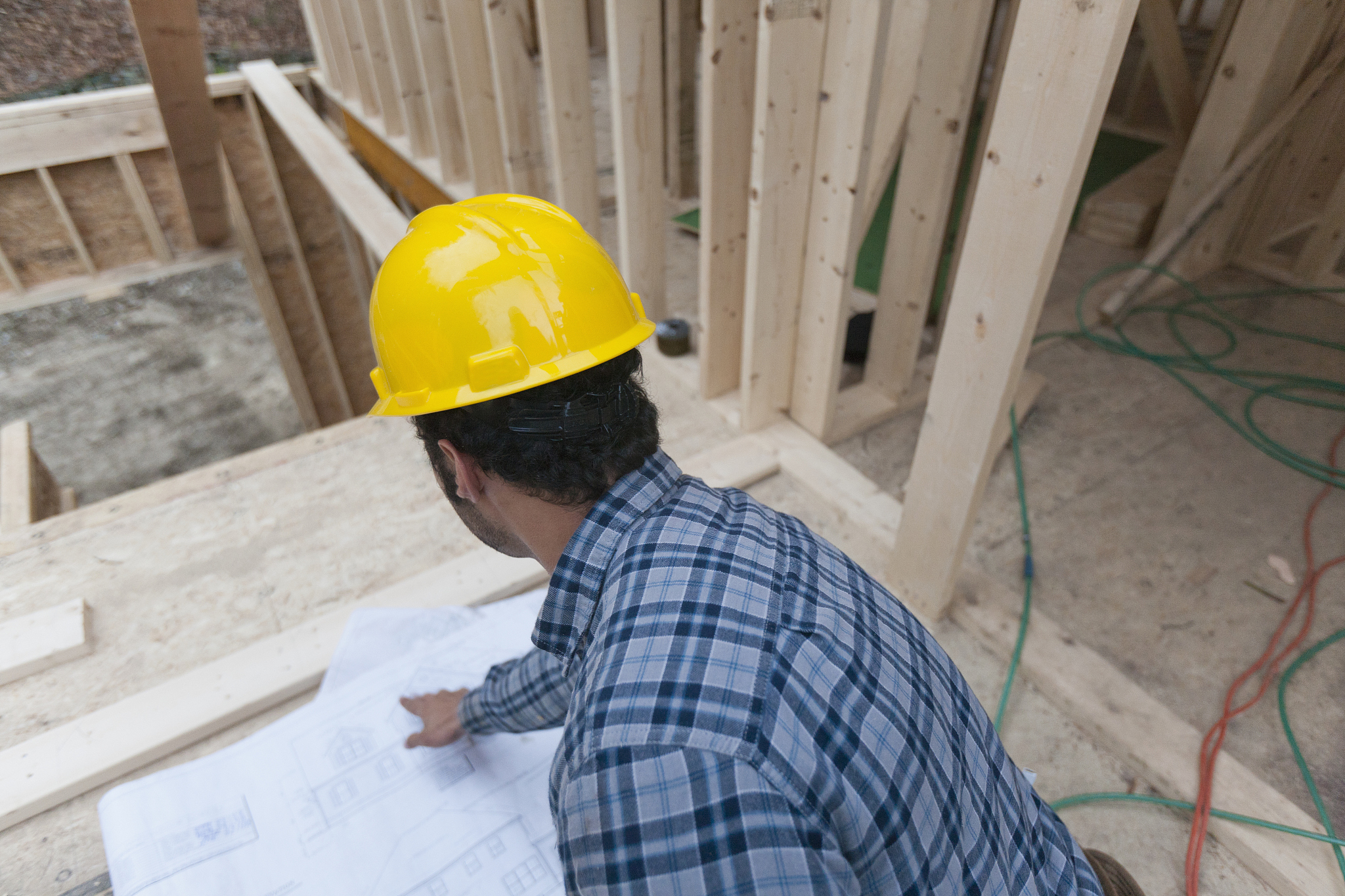 carpenter reviewing house plans