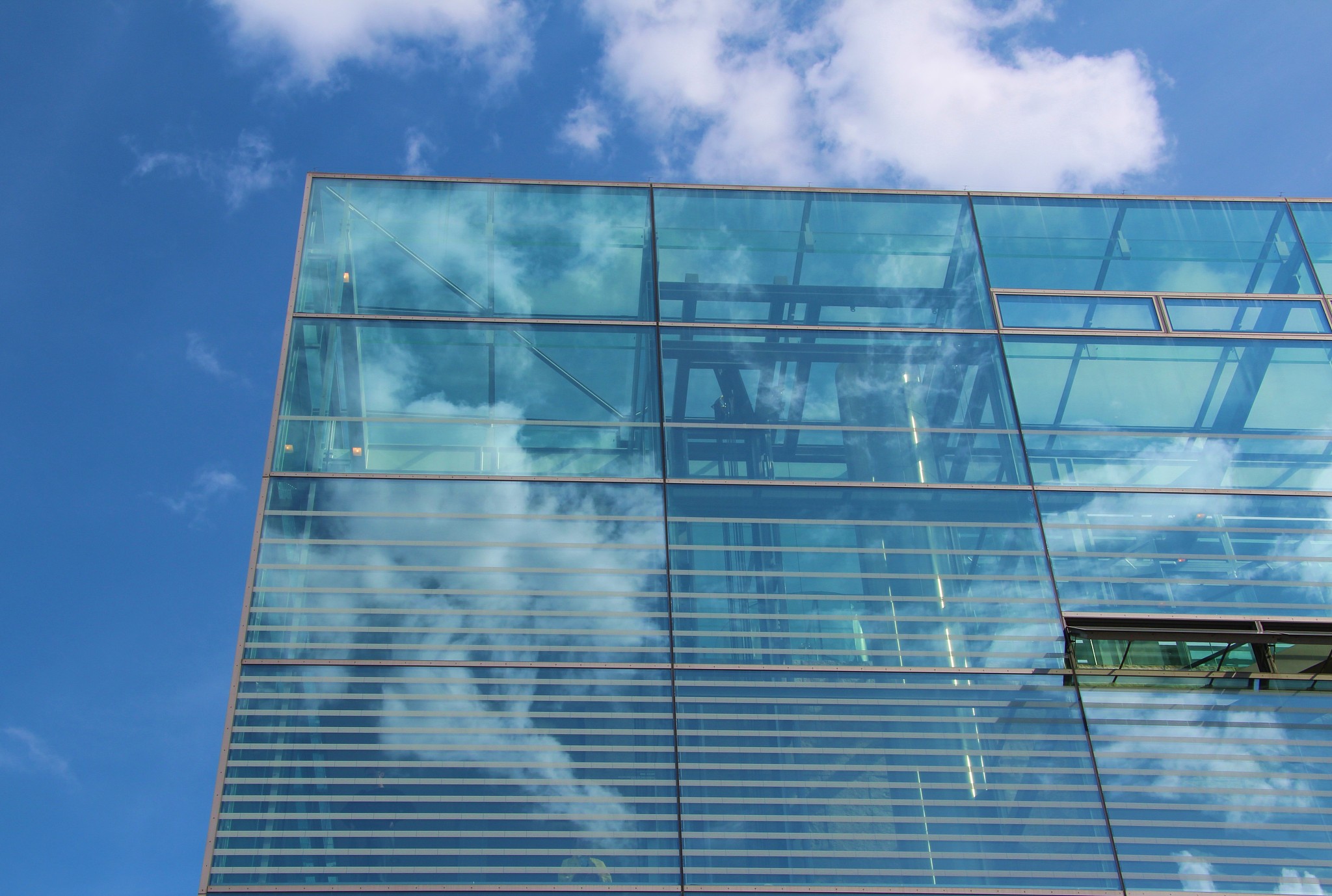 glass facade with clouds reflection