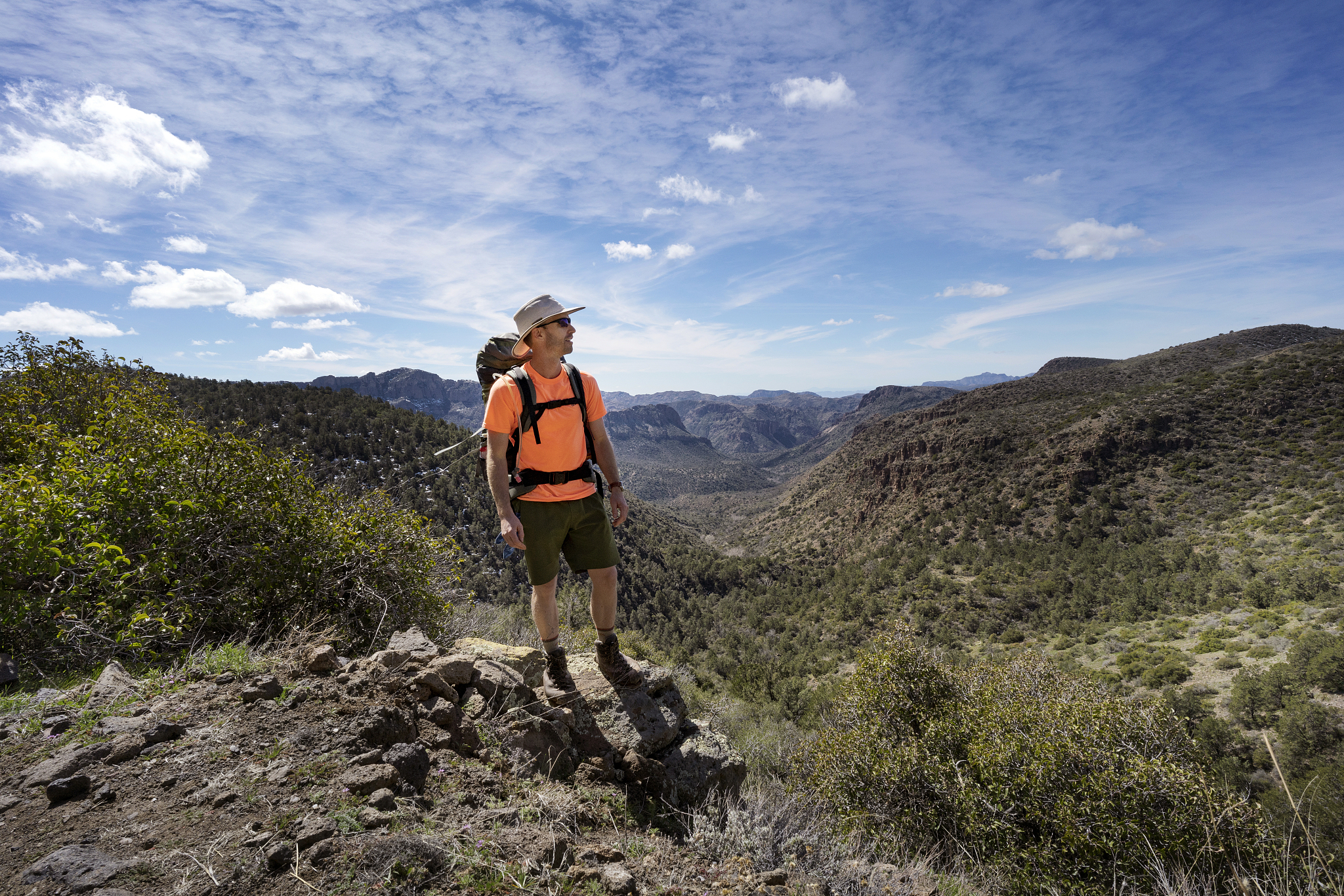man takes in nature view from trail overlooking superstition mou