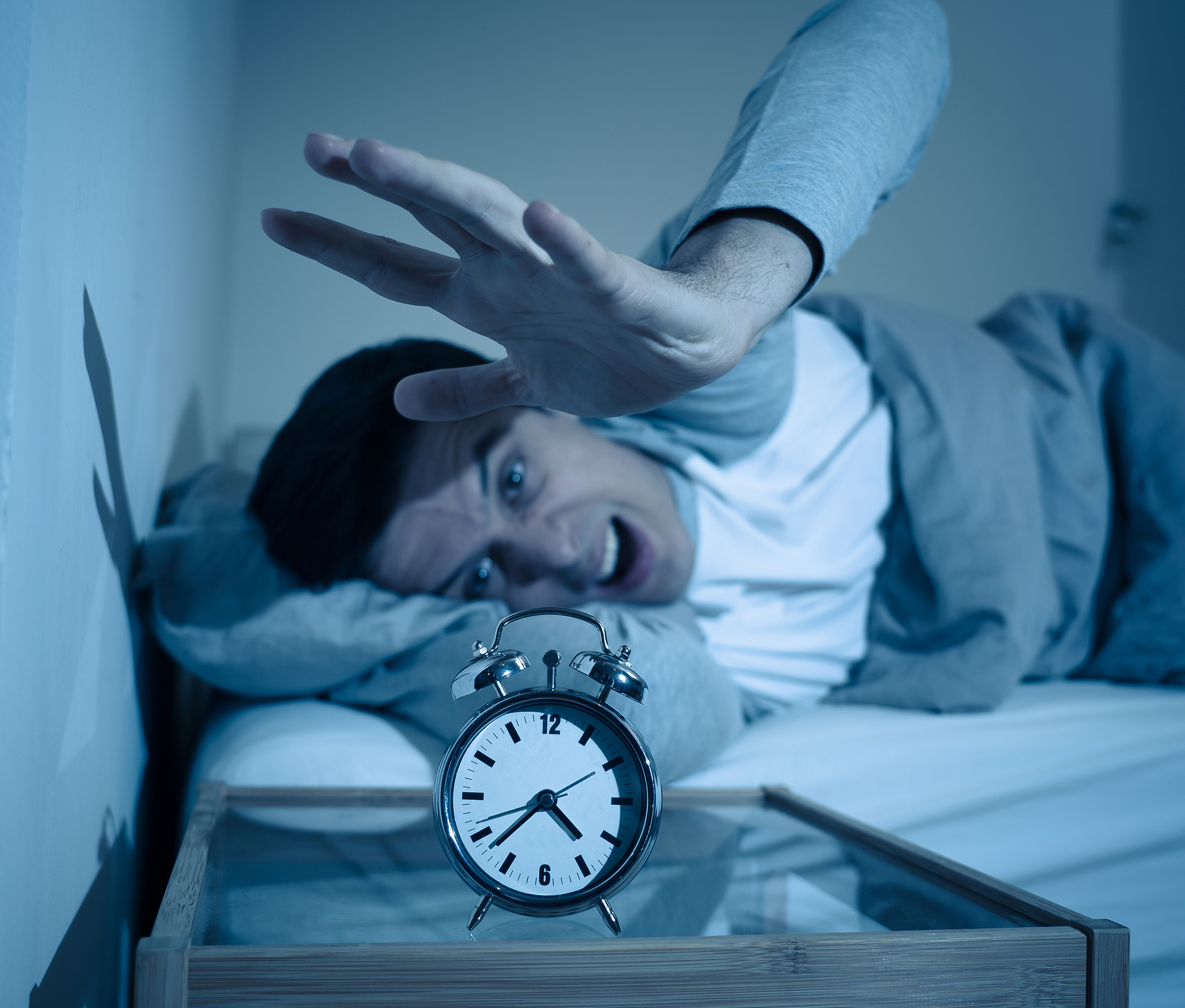 sleepless and desperate young man awake at night not able to sle