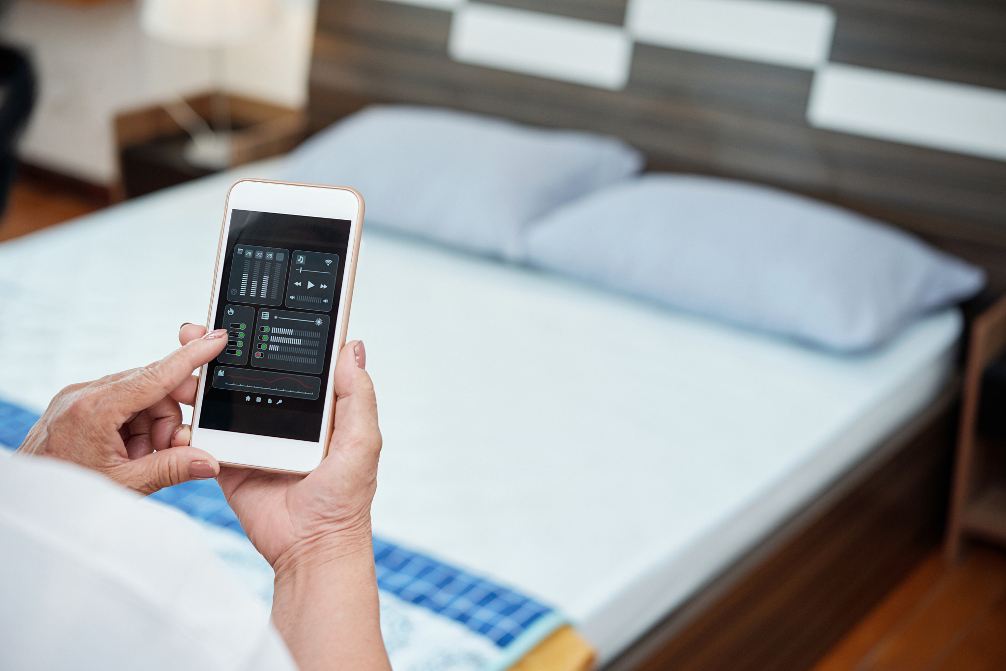 woman using smartphone in bedroom