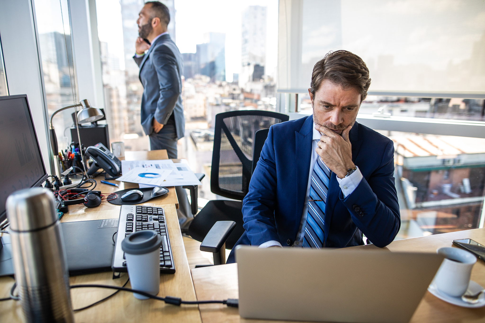 determined businessman using laptop in office